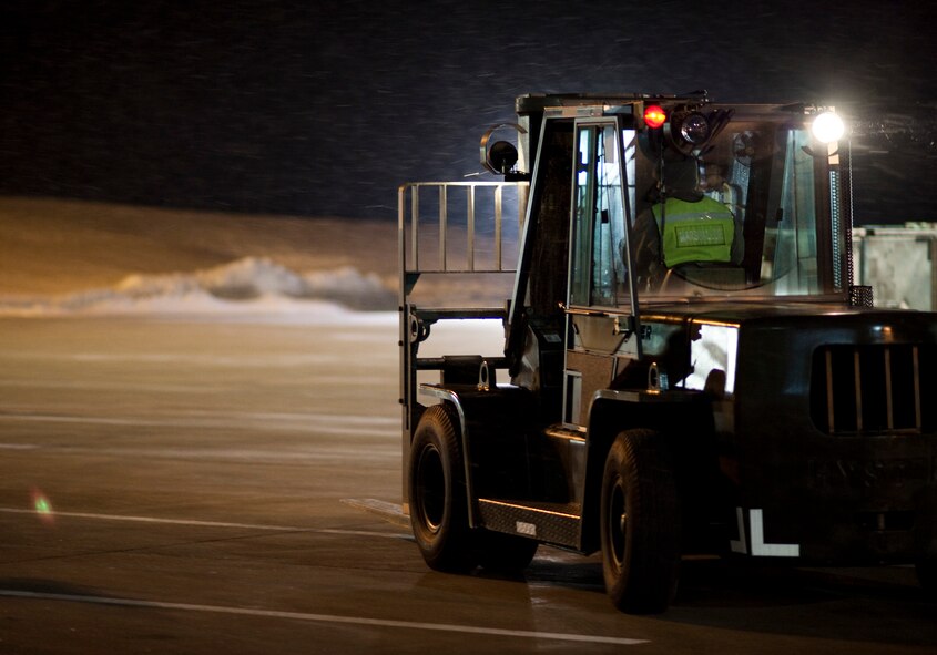 A 6,000-pound forklift drives to pick up another pallet outside Hangar 949 Jan. 28, 2010, at Misawa Air Base, Japan. The 35th Logistics Readiness Squadron cargo deployment function kept operating regardless of the 2.4 inches of snowfall and freezing temperatures ensuring the equipment was ready to go when its plane arrived. (U.S. Air Force photo/Staff Sgt. Samuel Morse)