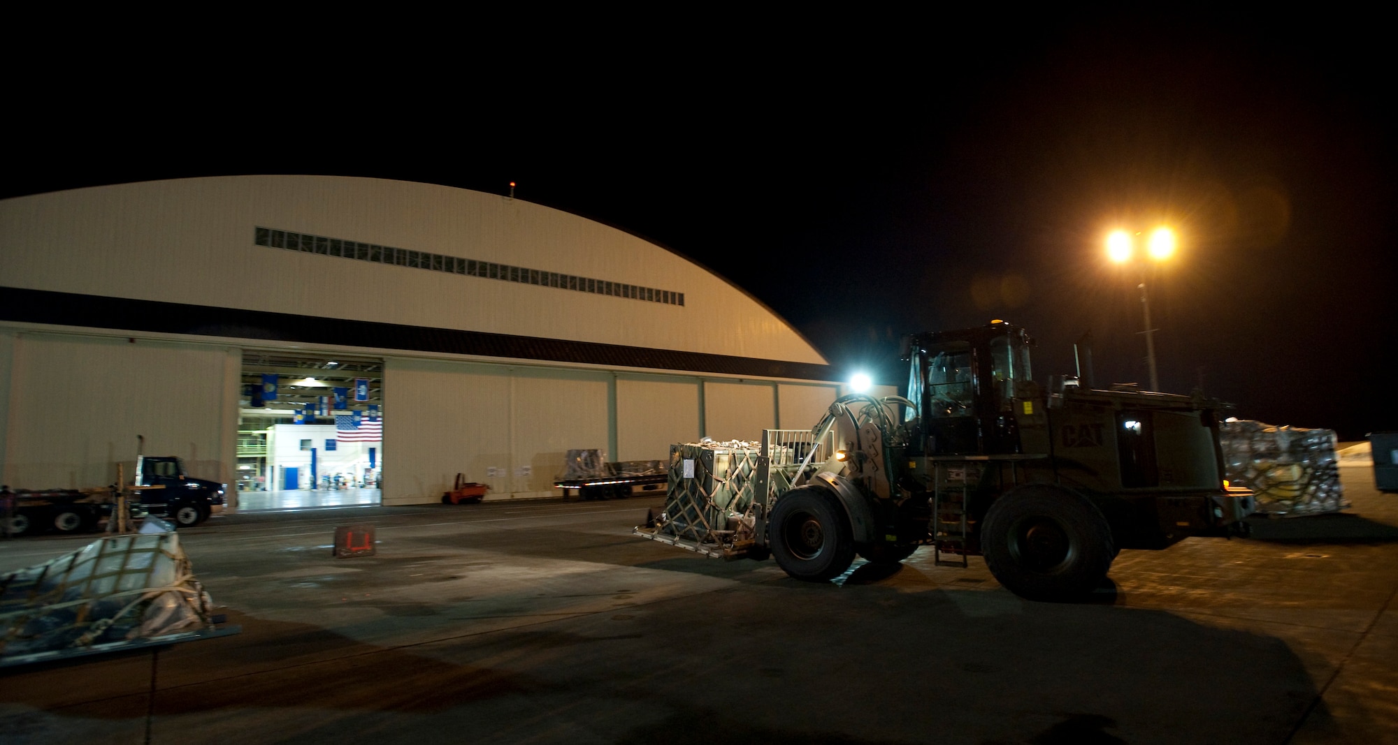 MISAWA AIR BASE, Japan -- A 10,000-pound forklift brings an aircraft pallet into Hangar 949 during an operational readiness exercise Jan. 28. The 35th Logistics Readiness Squadron cargo deployment function works around-the-clock to make sure necessary equipment and cargo are ready for flight. (U.S. Air Force photo/Staff Sgt. Samuel Morse)