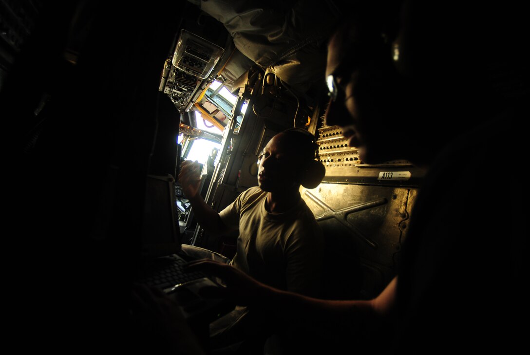 U.S. Air Force Senior Airman Roderick Wilson, center, and Senior Airman Crispin Hasley, guidance and control systems specialists assigned to the 36th Aircraft Maintenance Squadron, Anderson Air Force Base, Guam, review flight information aboard a B-52 Stratofortress prior to a mission in support of Exercise Cope North, Feb. 9, 2010. The B-52 aircraft is assigned to the 20th Expeditionary Bomb Squadron, Barksdale AFB, La. The United States Air Force and the Japanese Air Self-Defense Force conduct Cope North annually to increase combat readiness and interoperability, concentrating on coordination and evaluation of air tactics, techniques and procedures.  The ability for both nations to work together increases their preparedness to support real-world contingencies.  (U.S. Air Force photo by Staff Sgt. Jacob N. Bailey)