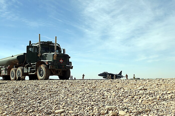Marines from Marine Wing Support Squadron 372, Marine Aircraft Group 40, Marine Expeditionary Brigade-Afghanistan, refuel an AV-8/B Harrier from Marine Attack Squadron 231, at the new fuel pits here, Feb. 10.