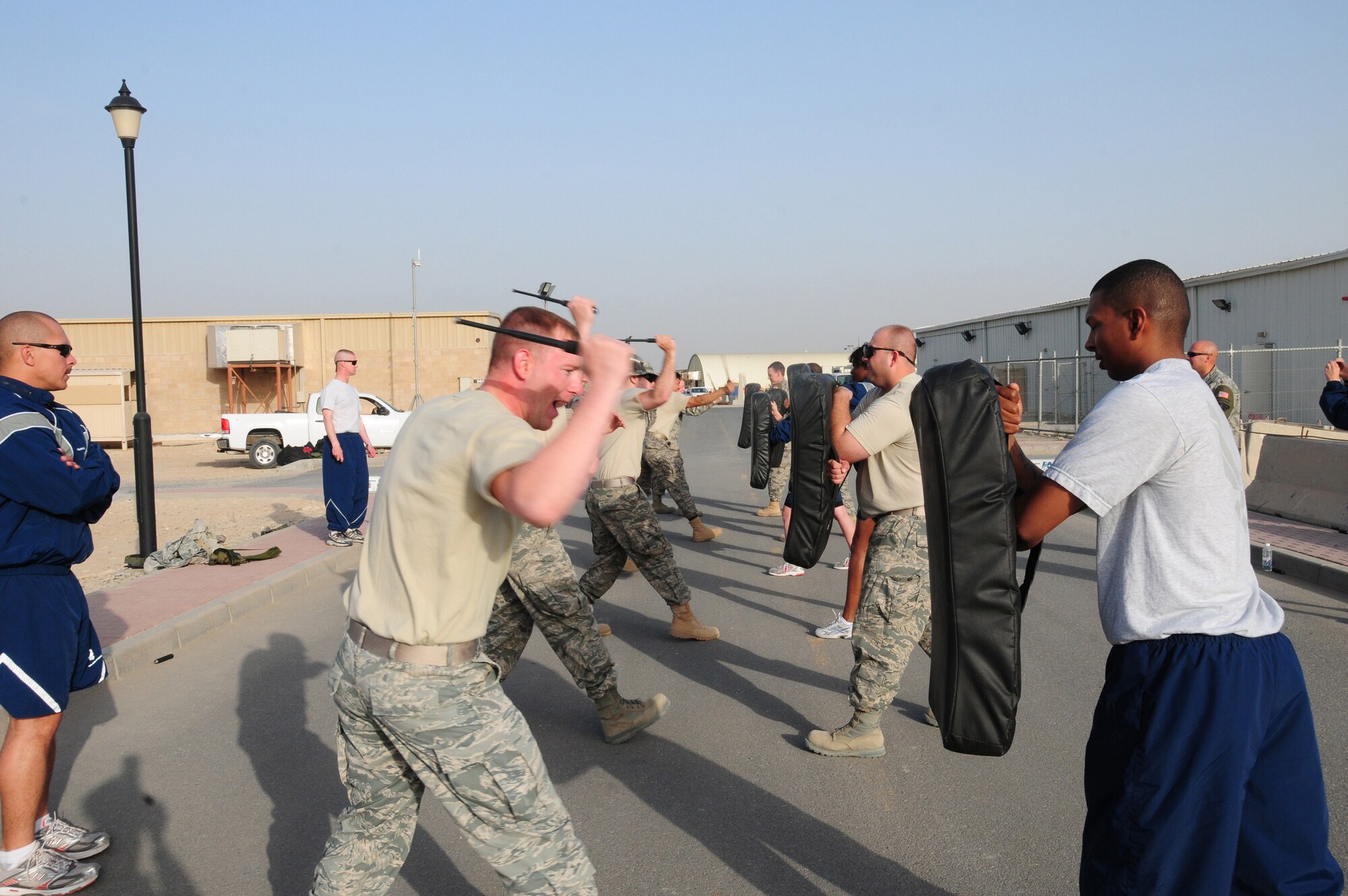 U.S. Air Force members of the 386th Expeditionary Security Forces Squadron Force Protection flight learn new self defense techniques during an asp training session Feb. 9, 2010 at an air base in Southwest Asia. The course is designed to prepare inbound Airmen to handle any hostile situation that may arise during their time downrange. (U.S. Air Force photo by Staff Sgt. Lakisha A. Croley/Released)