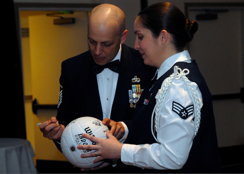 VANDENBERG AIR FORCE BASE, Calif. -- Senior Airman Rachel Turner presents the traditional volleyball to Master Sgt. Andrew Colsch, both of the 30th Logistics Readiness squadron, here Tuesday, Feb. 9, 2010. Each Airman Leadership School class plays a game of volleyball against Vandenberg first sergeants. (U.S. Air Force photo/Senior Airman Ashley Reed)
