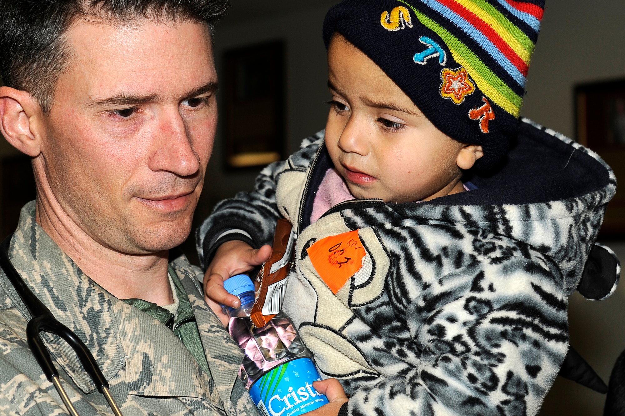 Master Sgt. Jan Fink holds a young avalanche survivor who was medically evacuated Feb. 9, 2010, to Craig Joint Theater Hospital at Bagram Airfield, Afghanistan. Dozens of Afghans were taken to Bagram Airfield after avalanches struck a mountain pass in the Parwan Province. Sergeant Fink is assigned to the 455th Expeditionary Medical Group. (U.S. Air Force photo by/Tech. Sgt. Jeromy K. Cross)