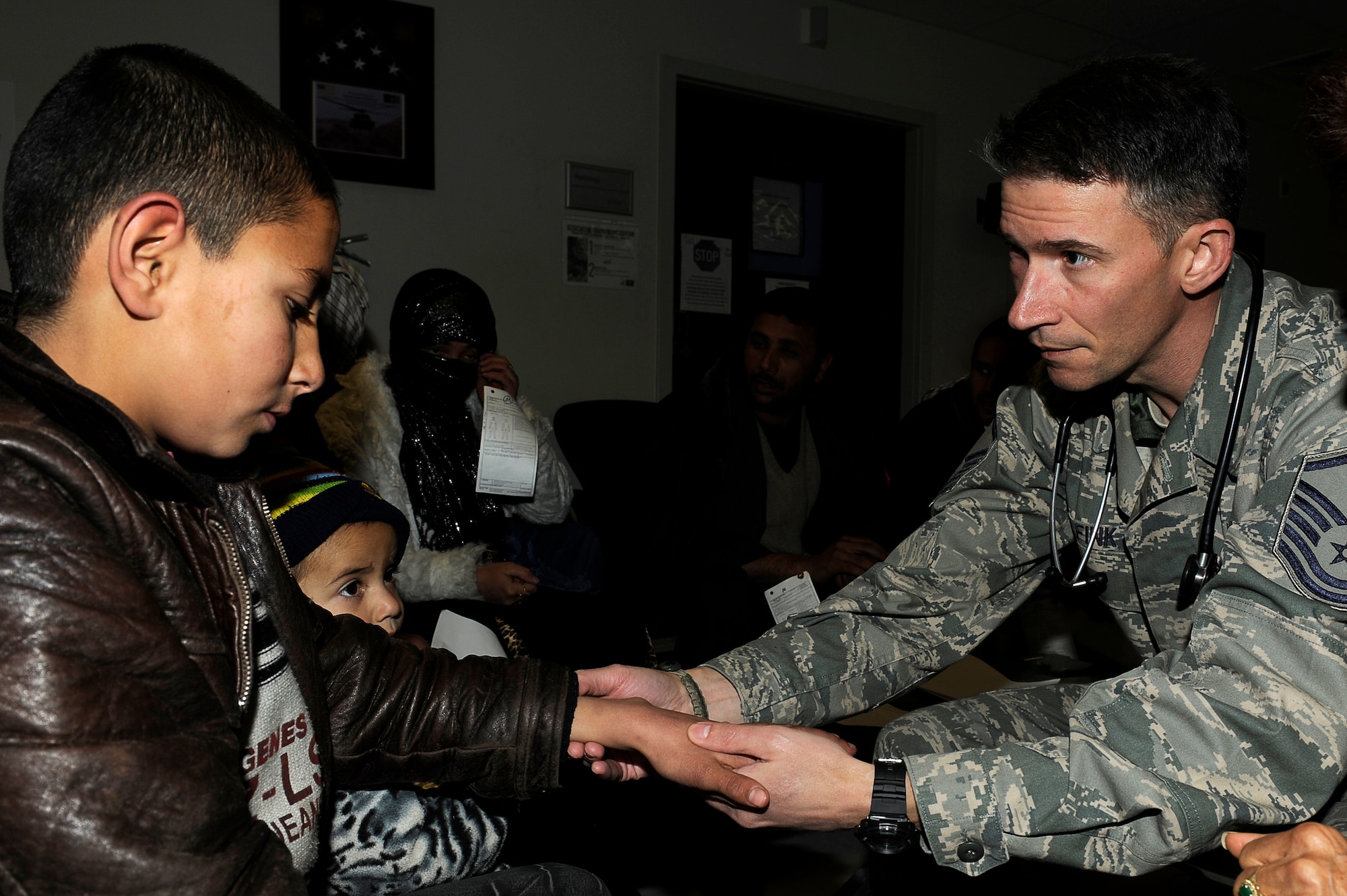 Master Sgt. Jan Fink assesses an avalanche survivor's wrist Feb. 9, 2010, at Craig Joint Theater Hospital at Bagram Airfield, Afghanistan. Dozens of Afghans were taken to Bagram Airfield after avalanches struck a mountain pass in the Parwan Province. Sergeant Fink is assigned to the 455th Expeditionary Medical Group. (U.S. Air Force photo by/Tech. Sgt. Jeromy K. Cross)