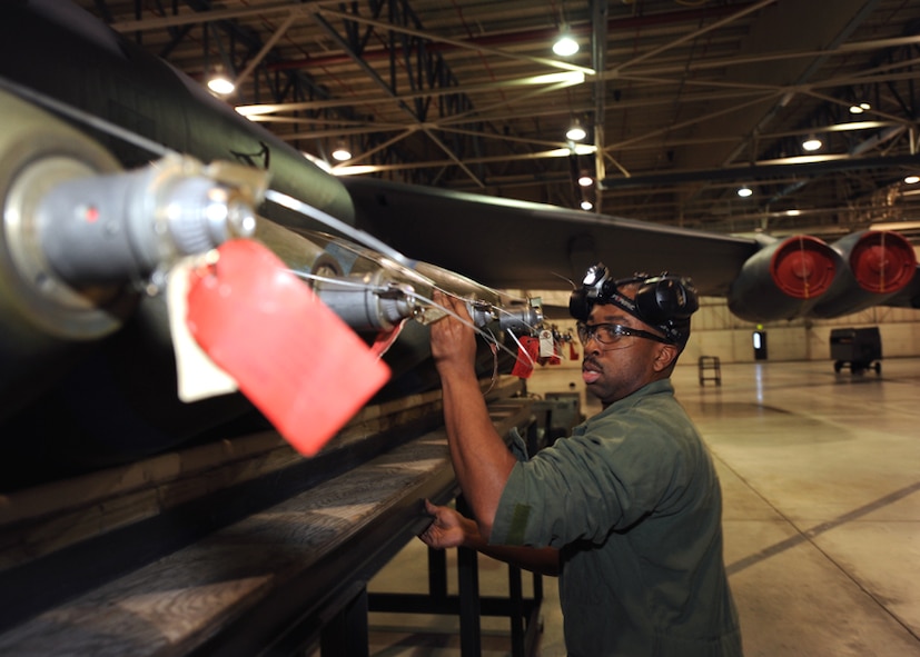 MINOT AIR FORCE BASE, N.D. - Staff Sgt. Devonde Reuben, 5th Aircraft Maintenance Squadron armament systems team member, inspects M-117 bomb training munitions during a load crew of the quarter competition here Feb. 5. Load crew competitions build camaraderie and ensure weapons Airmen maintain proficiency. (U.S. Air Force photo by Senior Airman Sharida Jackson)