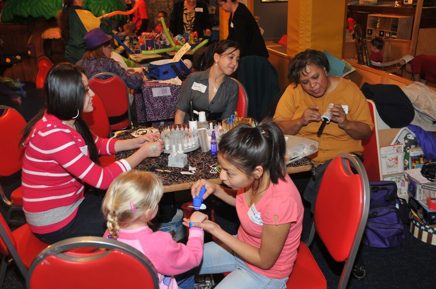 OFFUTT AIR FORCE BASE, Neb. -- Children gather in the party zone to explore crafts, games and recreational fun during the deployed family dinner at the community center Feb. 9.  Organizations and volunteers from across Offutt and in the local community come together each quarter to plan an event for the families of deployed military members. This event featured a free dinner and games for children and educational guidance for spouses to help them with separation. U.S. Air Force photo by Jeff W. Gates.