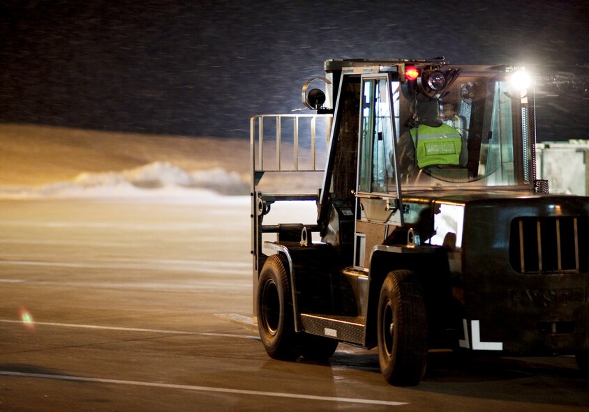 A 6,000-pound forklift drives to pick up another pallet near a hangar Jan. 28, 2010, at Misawa Air Base, Japan. The 35th Logistics Readiness Squadron cargo deployment function kept operating regardless of the 2.4 inches of snowfall and freezing temperatures ensuring the equipment was ready to go when its plane arrived. (U.S. Air Force photo/Staff Sgt. Samuel Morse)