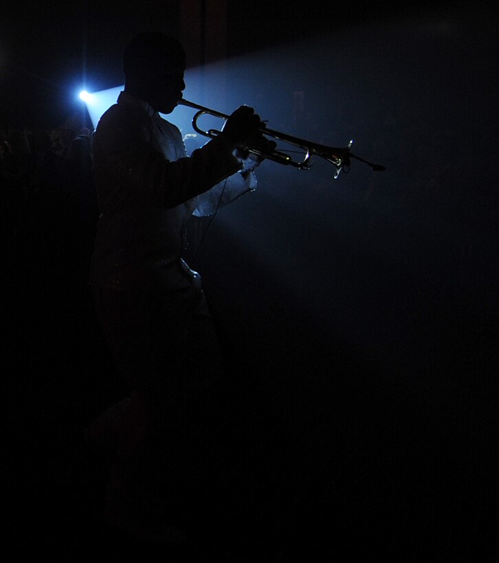 Hampton, Va. -- Senior Airman Anthoney Williams, trumpet player, is shown silhouetted against the spotlight during the Tops in Blue performance at the Hampton Roads Convention Center Feb. 9. Tops in Blue, the Air Force’s premier entertainment group, is composed of vocalists and instrumentalists representing a wide range of career fields who tour all over the world captivating military and civilian audiences with high energy shows. (U.S. Air Force photo/Airman Rebecca Montez)