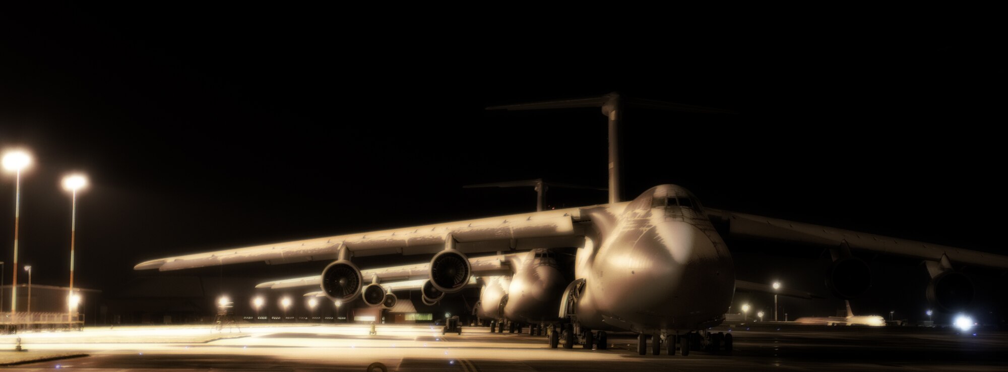 RAF MILDENHALL, England -- Three C-5 Galaxy aircraft, one of the largest military aircraft in the world, sit in the snow after dark Feb. 10.  (U.S. Air Force photo/Staff Sgt. Christopher L. Ingersoll)