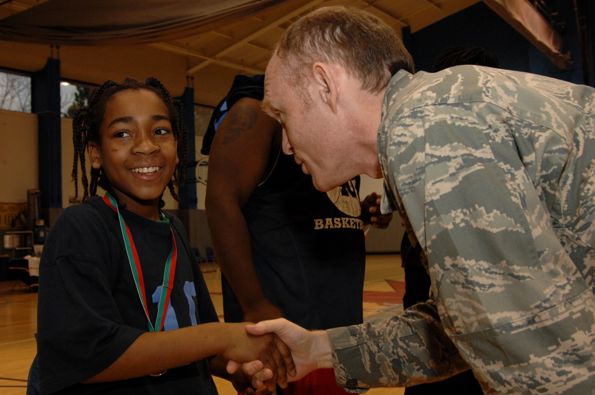 Col. Bill Porter, 96th Air Base Wing vice commander, shakes the hand of Amante Gice, Walton County Tivoli Cubs basketball team, during the Special Olympics Florida 2010 Northwest State Basketball Tournament at Hurlburt Field Feb. 6. More than 250 athletes from 10 counties in northwestern Florida participated in this year's games. (U.S. Air Force photo by Senior Airman Matthew Loken)
