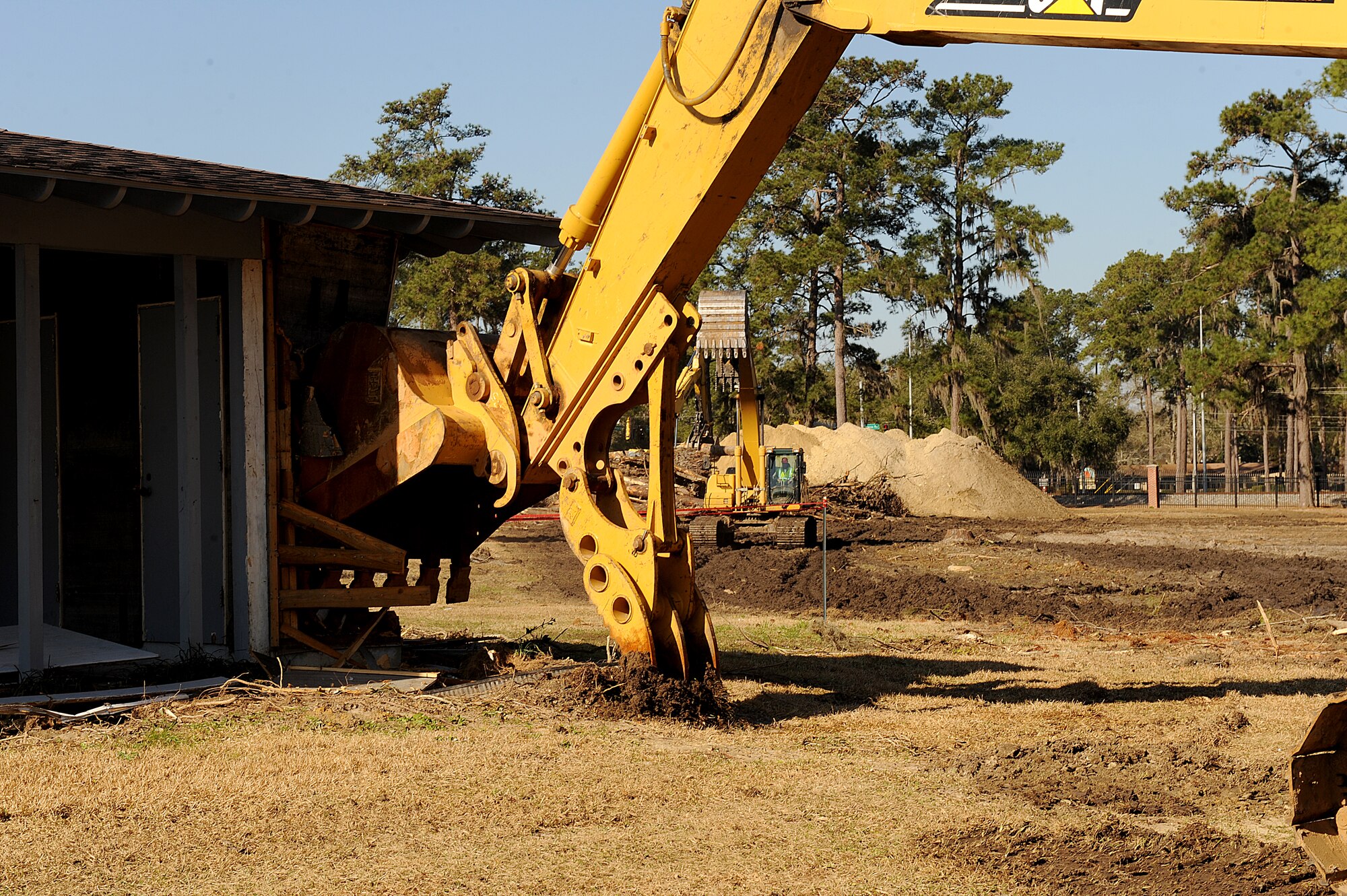 MOODY AIR FORCE BASE, Ga. -- A construction worker uses a bulldozer bucket to begin destruction of the first wing leadership house here Feb. 8. A new Child Development Center, which will accommodate 276 children, will be built in place of the houses. (U.S. Air Force photo by Airman 1st Class Joshua Green)
