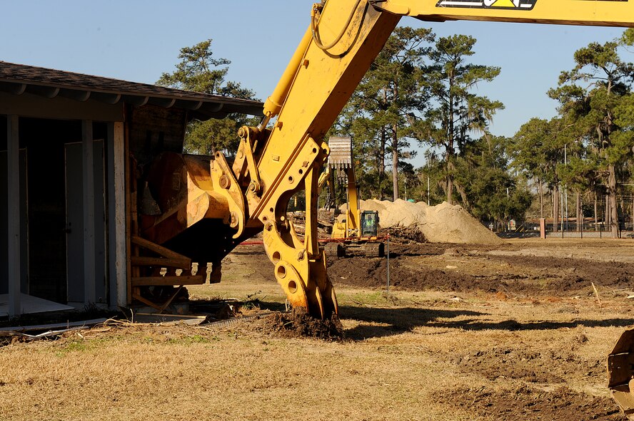 MOODY AIR FORCE BASE, Ga. -- A construction worker uses a bulldozer bucket to begin destruction of the first wing leadership house here Feb. 8. A new Child Development Center, which will accommodate 276 children, will be built in place of the houses. (U.S. Air Force photo by Airman 1st Class Joshua Green)
