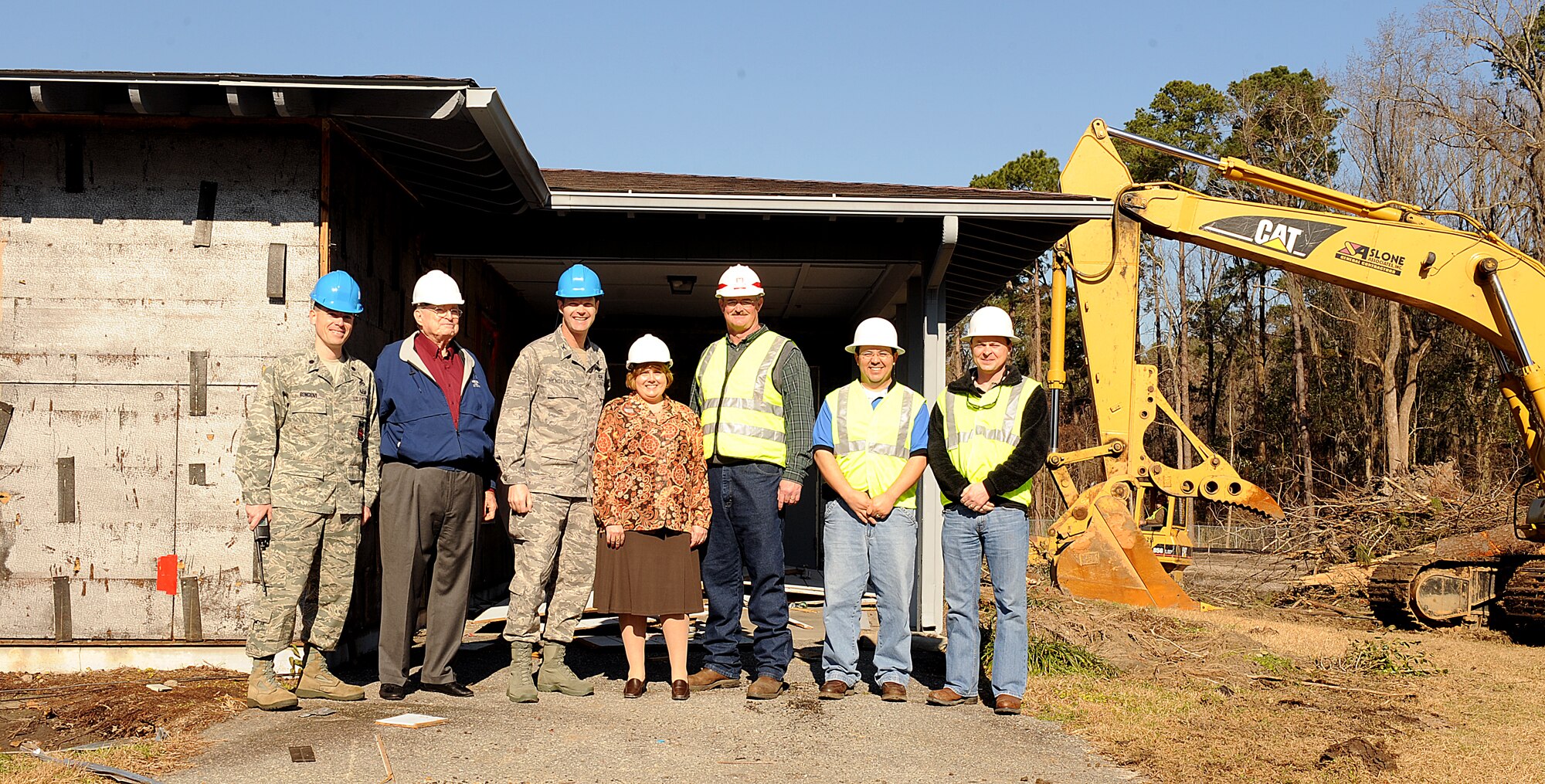 MOODY AIR FORCE BASE, Ga. -- Moody leaders, civilians and construction workers involved in the new Child Development Center construction project pose in front of the first house to be destroyed here Feb. 8. The destruction of the wing leadership houses signified the start of the construction project. (U.S. Air Force photo by Airman 1st Class Joshua Green) 
