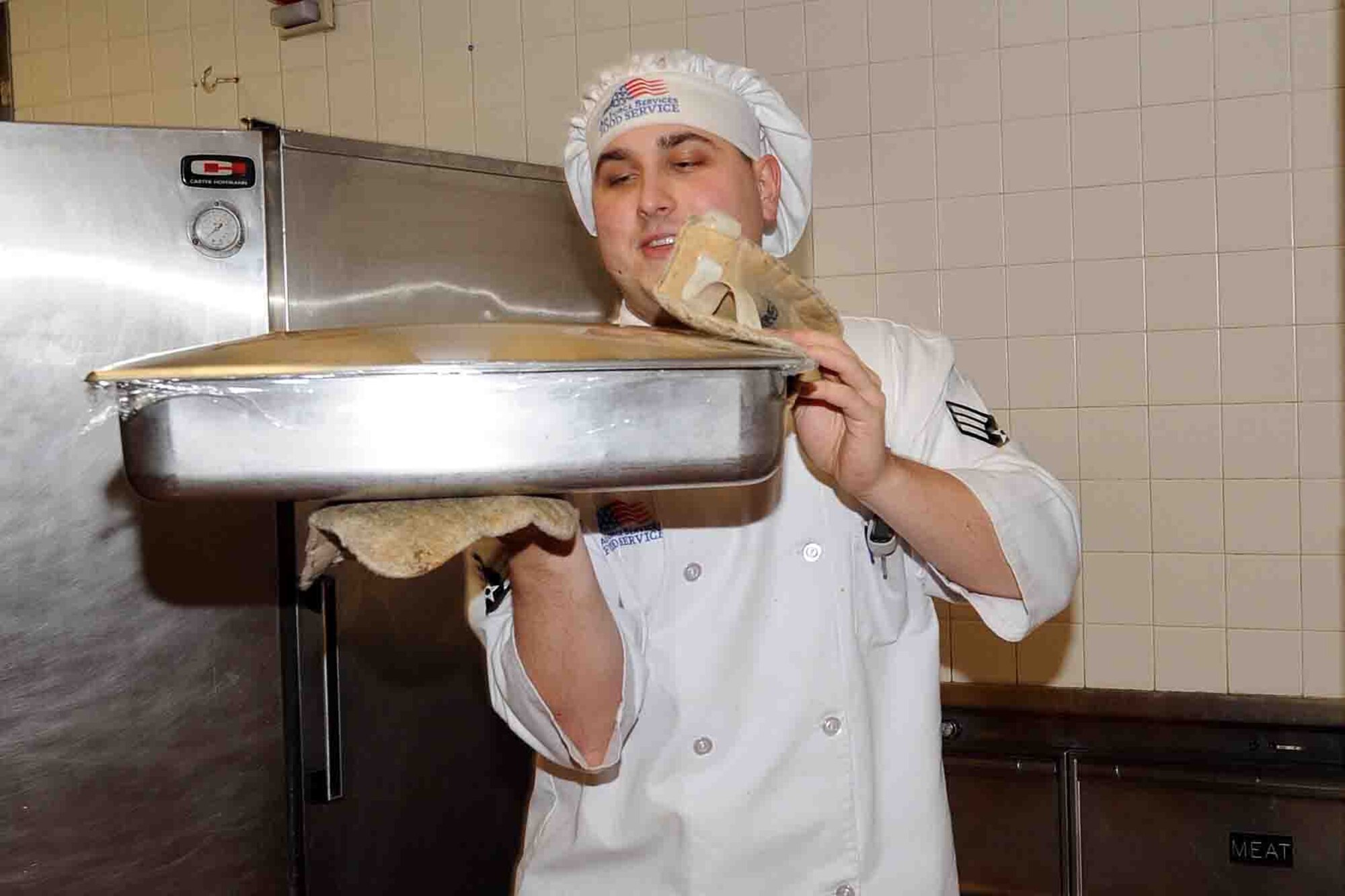 OFFUTT AIR FORCE BASE, Neb. -- Senior Airman Anthony Joseph, a food service apprentice with the 55th Force Support Squadron, carries a dish out to the food service line during lunch at the King Dining Facility here Feb. 8. The 2010 Air Force Hennessy Team visited Offutt Offutt Feb. 6 - 10 in their quest to determine the best dining facilities in the Air Force. Offutt is competing against six other bases in the multi-facility category. The results of the competition are expected to be announced in April.  U.S. Air Force photo by Kendra Williams