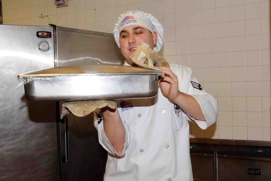 OFFUTT AIR FORCE BASE, Neb. -- Senior Airman Anthony Joseph, a food service apprentice with the 55th Force Support Squadron, carries a dish out to the food service line during lunch at the King Dining Facility here Feb. 8. The 2010 Air Force Hennessy Team visited Offutt Offutt Feb. 6 - 10 in their quest to determine the best dining facilities in the Air Force. Offutt is competing against six other bases in the multi-facility category. The results of the competition are expected to be announced in April.  U.S. Air Force photo by Kendra Williams