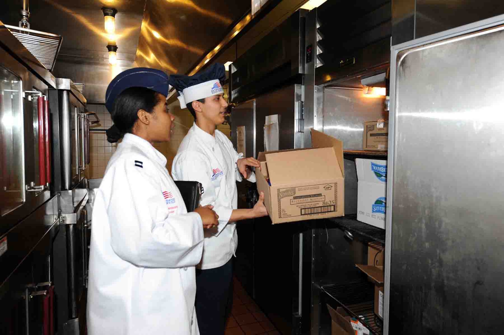 OFFUTT AIR FORCE BASE, Neb. -- Airman 1st Class Billy Garcia, flight kitchen clerk with the 55th Force Support Squadron, shows Capt. Anquenetta Blount, chief of Headquarters Air Force Services Agency Services Strategic Plans Branch, items in the King Dining Facility's inventory here Feb. 8 during the 2010 Air Force Hennessey Team Evaluation. The Air Force evaluation team visited Offutt Feb. 6 - 10 in their quest to determine the best dining facilities in the Air Force. Offutt is competing against six other bases in the multi-facility category. The results of the competition are expected to be announced in April.  U.S. Air Force photo by Kendra Williams