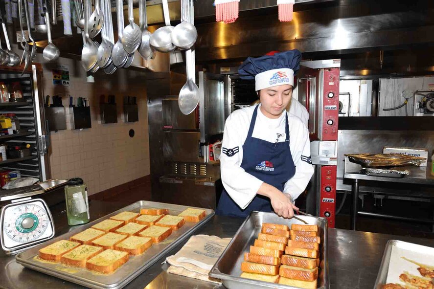 OFFUTT AIR FORCE BASE, Neb. -- Airman 1st Class Elizabeth Heilig, a food service apprentice with the 55th Force Support Squadron, prepares garlic toast for lunch at the King Dining Facility here Feb. 8 during the 2010 Air Force Hennessey Team Evaluation. The Air Force evaluation team visited Offutt Feb. 6 - 10 in their quest to determine the best dining facilities in the Air Force. Offutt is competing against six other bases in the multi-facility category. The results of the competition are expected to be announced in April.  U.S. Air Force photo by Kendra Williams