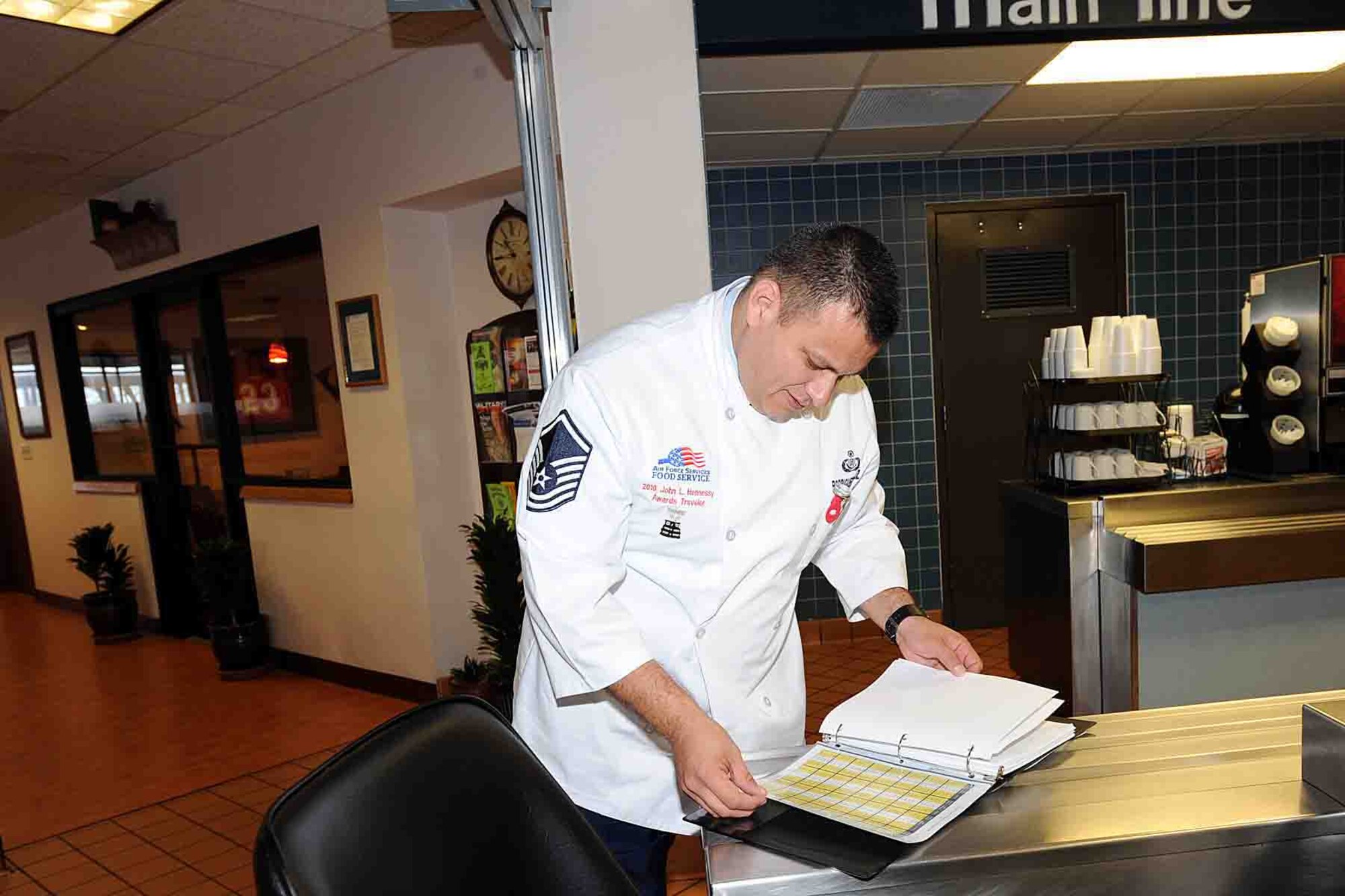 OFFUTT AIR FORCE BASE, Neb. -- Master Sgt. Guadalupe Rodgriguezvaldez, the Air Force food and beverage manager at Headquarters Air Force Services Agency and a 2010 Air Force Hennessy Team evaluator, goes through a log binder at the King Dining Facility here as part of the Hennessy evaluation Feb. 8.  The Air Force evaluation team visited Offutt Feb. 6 - 10 in their quest to determine the best dining facilities in the Air Force. Offutt is competiting against six other bases in the multi-facility category. The results of the competition are expected to be announced in April.  U.S. Air Force photo by Kendra Williams