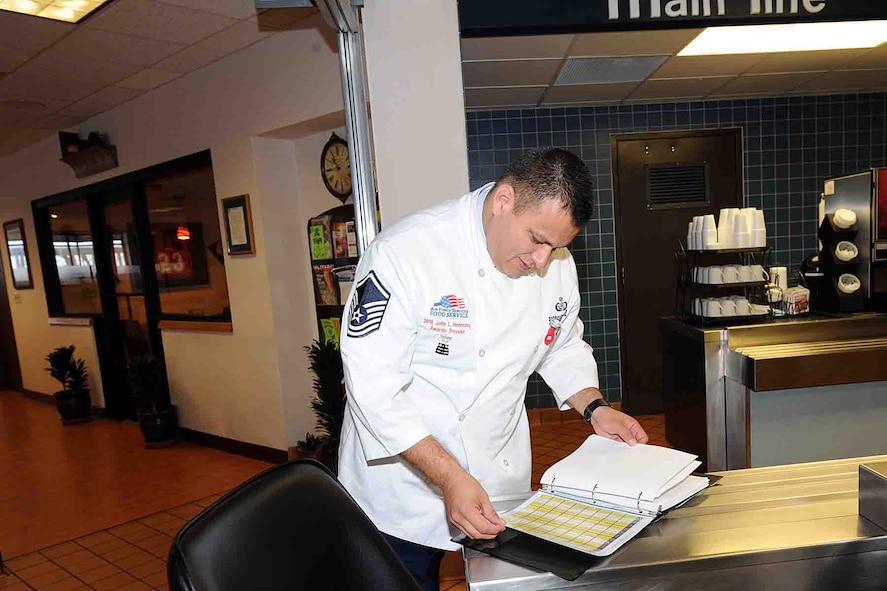 OFFUTT AIR FORCE BASE, Neb. -- Master Sgt. Guadalupe Rodgriguezvaldez, the Air Force food and beverage manager at Headquarters Air Force Services Agency and a 2010 Air Force Hennessy Team evaluator, goes through a log binder at the King Dining Facility here as part of the Hennessy evaluation Feb. 8.  The Air Force evaluation team visited Offutt Feb. 6 - 10 in their quest to determine the best dining facilities in the Air Force. Offutt is competiting against six other bases in the multi-facility category. The results of the competition are expected to be announced in April.  U.S. Air Force photo by Kendra Williams