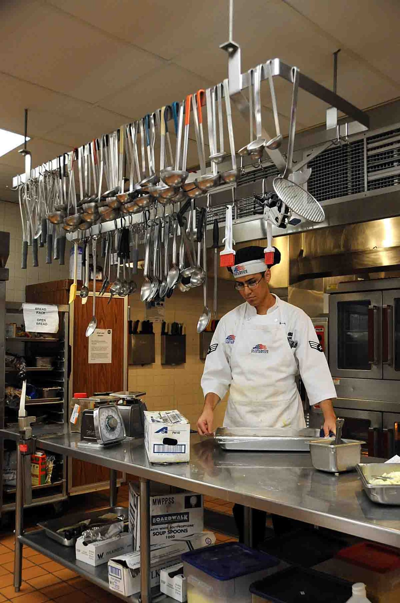 OFFUTT AIR FORCE BASE, Neb. -- Senior Airman Anthony Joseph, a food service apprentice with the 55th Force Support Squadron, seals a dish for an afternoon meal at the King Dining Facility here Feb. 8 during a visit by the 2010 Air Force Hennessy Evaluation Team.  The Air Force evaluation team visited Offutt Feb. 6 - 10 in their quest to determine the best dining facilities in the Air Force. Offutt is competing against six other bases in the multi-facility category. The results of the competition are expected to be announced in April.  U.S. Air Force photo by Kendra Williams