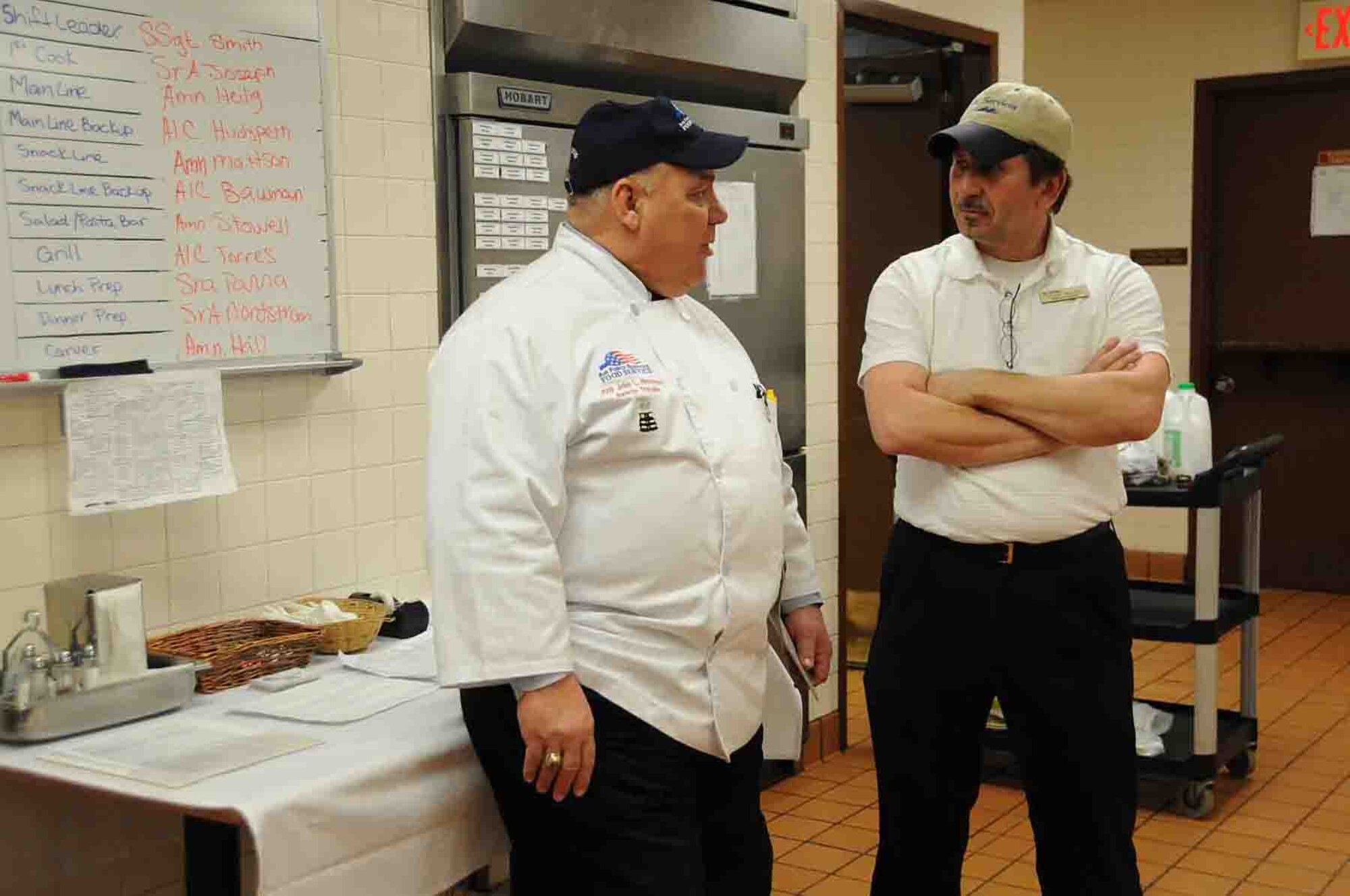 OFFUTT AIR FORCE BASE, Neb. -- Roy Steven Watson, a member of the National Restaurant Association and a 2010 Air Force Hennessy Team evaluator, talks with Terry Wilson, a manager with the dining facility contract company Black Hills Services, in the King Dining Facility Feb. 8 during the 2010 Air Force Hennessy Evaluation. The Air Force evaluation team visited Offutt Feb. 6 - 10 in their quest to determine the best dining facilities in the Air Force. Offutt is competing against six other bases in the multi-facility category. The results of the competition are expected to be announced in April.  U.S. Air Force photo by Kendra Williams