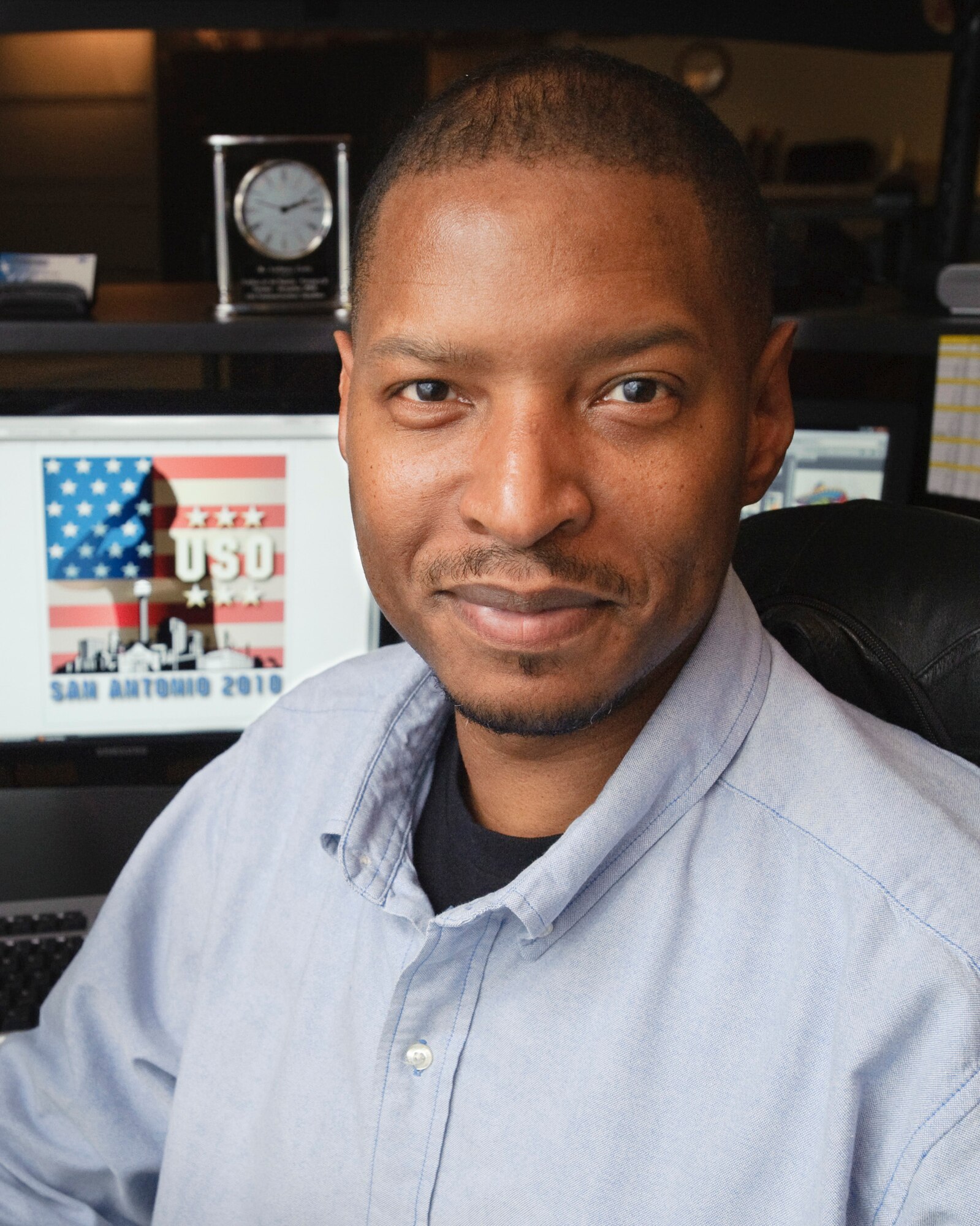 Tony Ervin, graphic designer with the 502nd Air Base Wing Operating Location Bravo Public Affairs office, won first place in the 2010 USO T-shirt design contest with his design incorporating national, military and local elements. (U.S. Air Force photo/Steve Thurow)