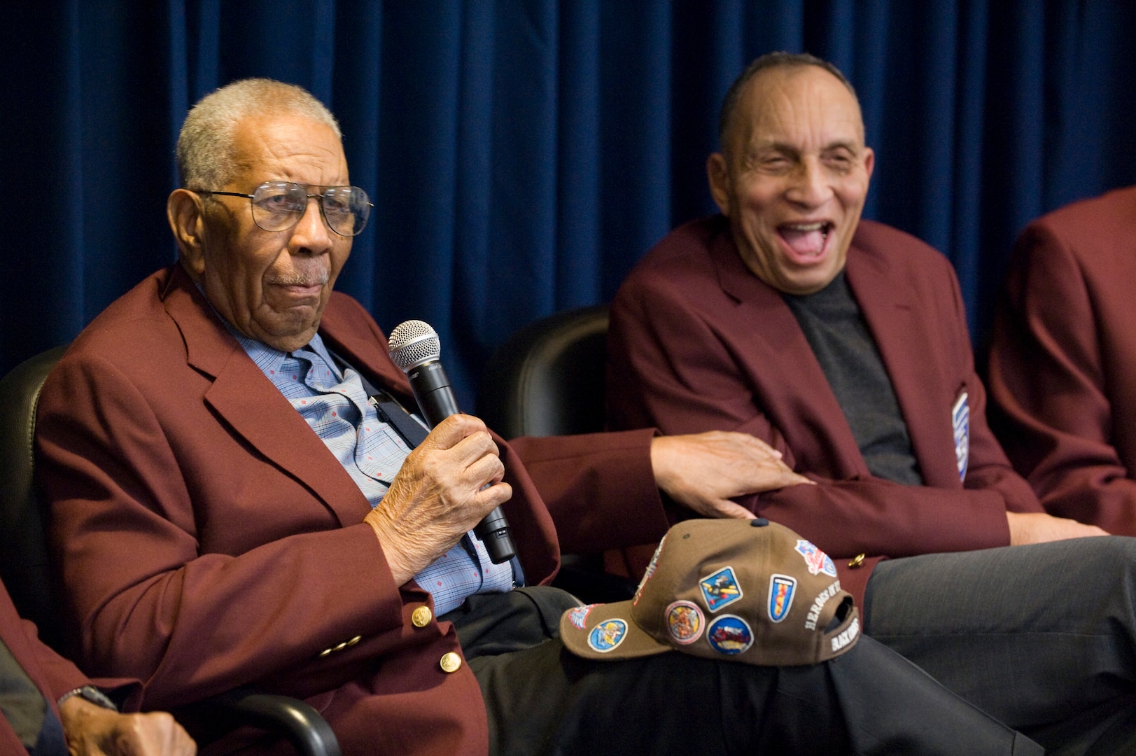 Warren Eusan and Dr. Gene Derricotte talk with the audience about their experiences as Tuskegee Airmen at the second annual Tuskegee Heritage Breakfast Feb. 8 at the 99th Flying Training Squadron here. (U.S. Air Force photo/Steve Thurow)
