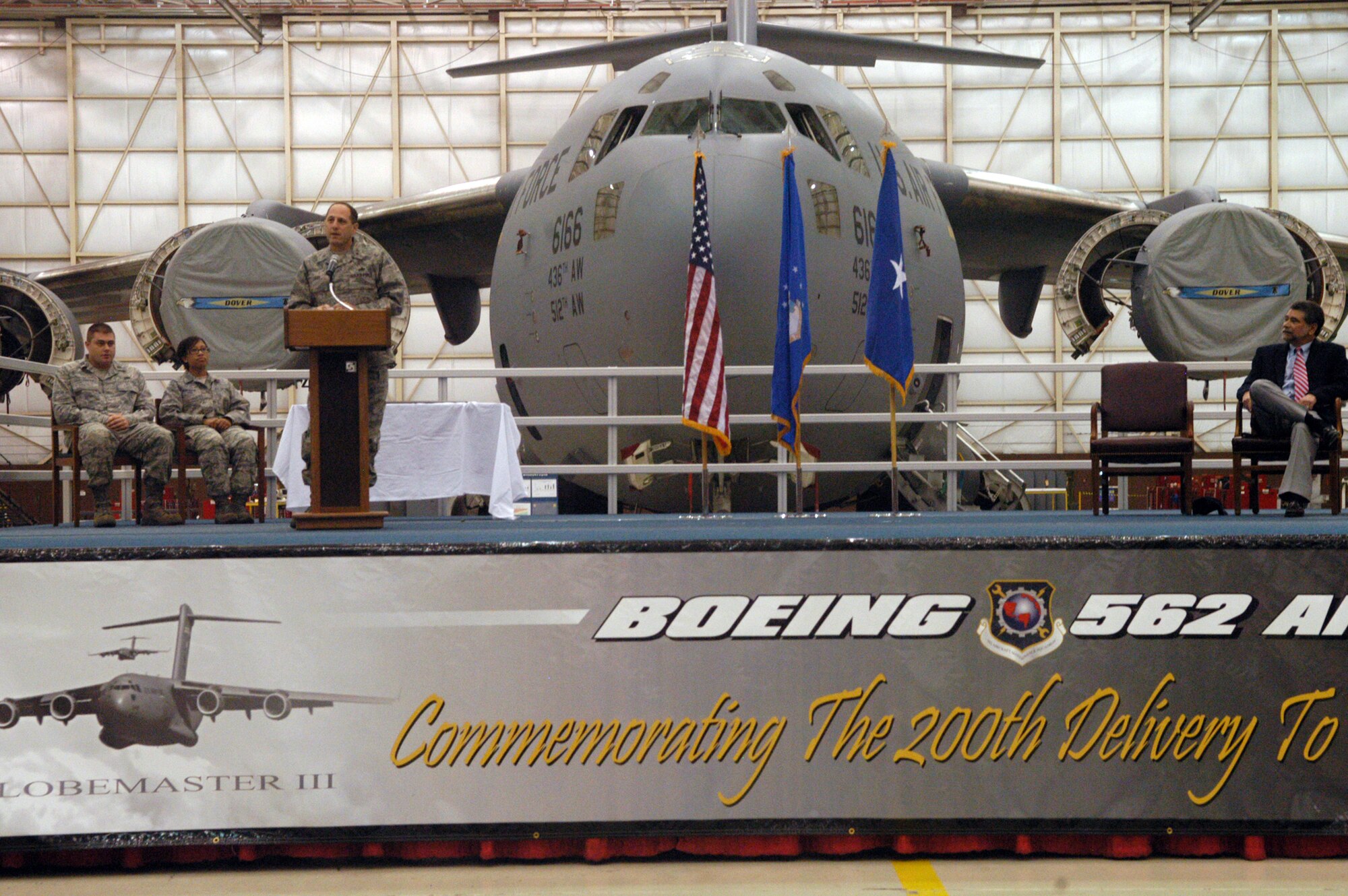 Brigadier General Lee Levy, podium at left, speaks at the ceremony commemorating the 200th C-17 delivery. U. S. Air Force photo by Sue Sapp