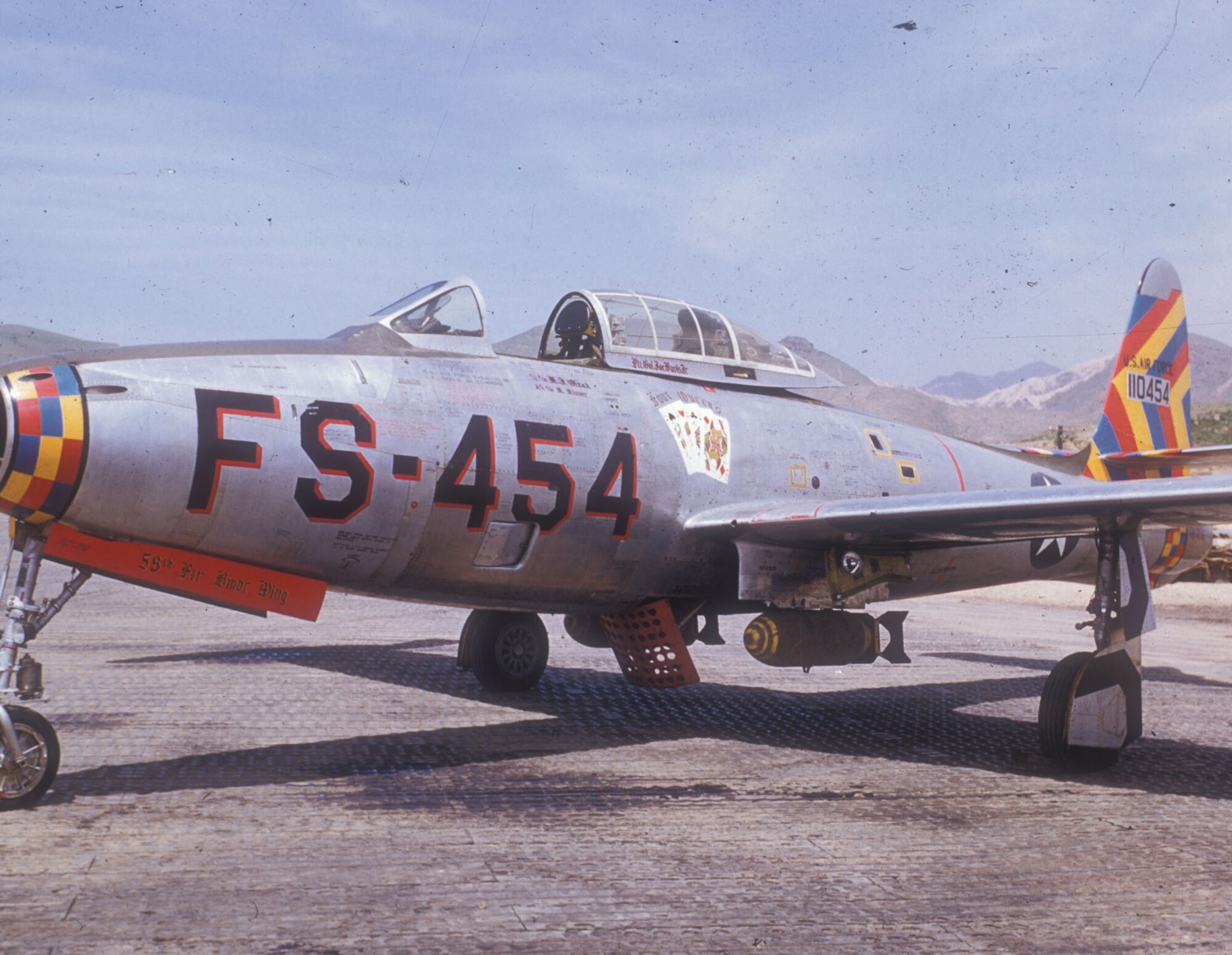 The brightly colored "Four Queens" armed with two 500-lb. bombs. (U.S. Air Force photo)