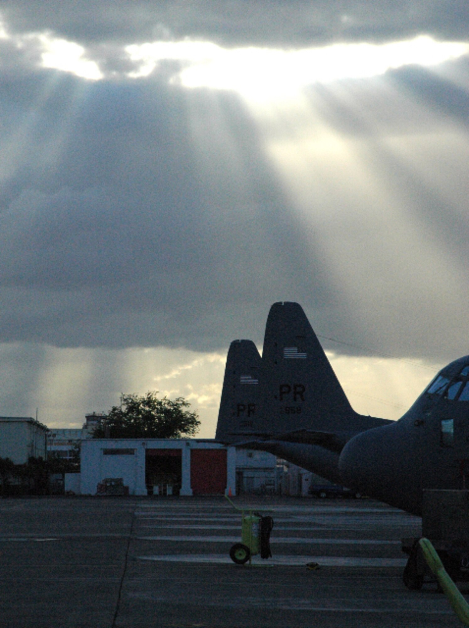 The day's last rays of light shine down on C-130 Hercules assigned to the Puerto Rico Air National Guard's 156th Airlift Wing Jan. 30 at Muniz Air Base, Puerto Rico. Approximately 50 Airmen and two nearby C-130s from the Air Force Reserve's 302nd Airlift Wing traveled to the Puerto Rican airbase to support two weeks of Haiti earthquake relief operations under the banner of Air Expeditionary Force Coronet Oak. In all, the Reservists flew more than 89 hours for a total of nine missions that took them back and forth into the U.S. to deliver more than 80 tons of supplies into Haiti, as well as medically evacuate 19 people. (U.S. Air Force photo/Staff Sgt. Stephen J. Collier)