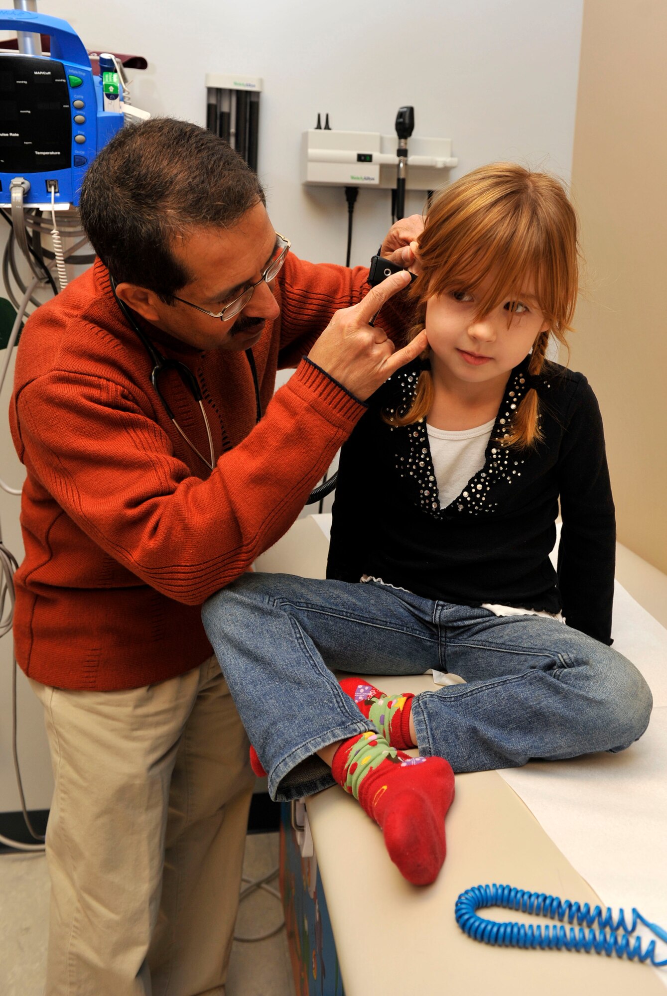 Dr. Anil Badhwar, a 19th Medical Operations Squadron contract physician, performs a check-up on Emme Bates, 5-year old daughter of Staff Sgt.  Cody Bates, 314th Aircraft Maintenance Squadron communication and navigation journeyman. The pediatric clinic is located on the first floor of the medical group building. (U.S. Air Force photo by Airman 1st Class Lausanne Pacheco)