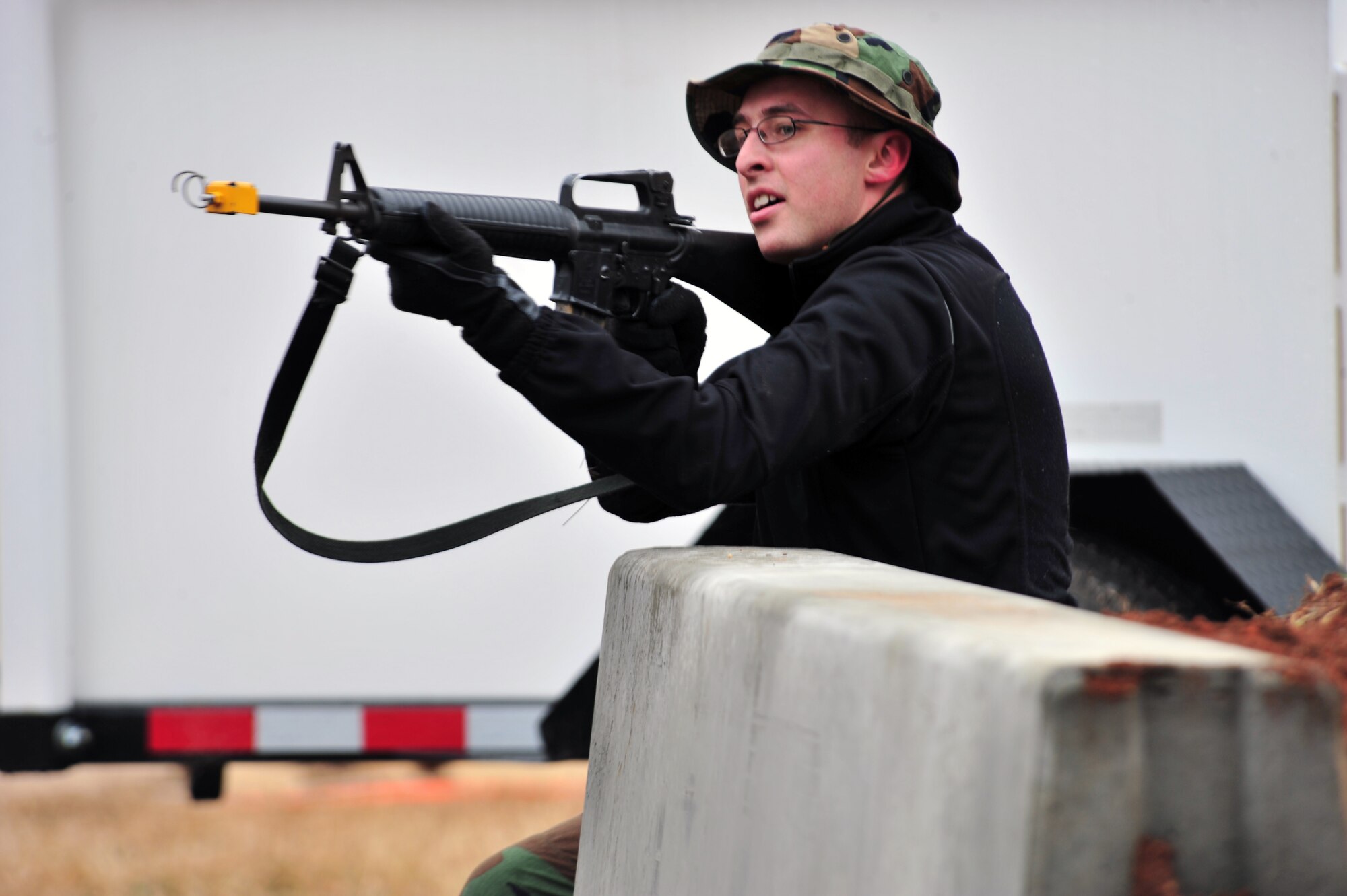 SHAW AIR FORCE BASE, S.C. -- Staff Sgt. Aaron Kirby, 20th Maintenance Operations Squadron and a member of the exercise evaluation team, simulates an attack on the fictional deployed location during the phase II operational readiness exercise here Feb. 9. The EET is responsible for aiding in the setup, supervision and grading of training scenarios. Shaw performs routine exercises throughout the year to ensure Airmen are ready for base or deployment attacks. (U.S. Air Force photo/Airman 1st Class Amber E. N. Jacobs)