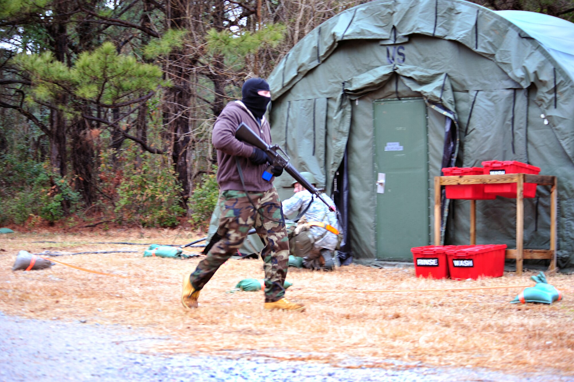 SHAW AIR FORCE BASE, S.C. -- Staff Sgt. Ferdinando Acerra, 20th Maintenance Operations Squadron and a member of the exercise evaluation team, runs into the fictional deployed location for an attack during the phase II operational readiness exercise here Feb. 9. The EET is responsible for aiding in the setup, supervision and grading of Phase II training scenarios. Shaw performs routine exercises throughout the year to ensure Airmen are ready for base or deployment attacks. (U.S. Air Force photo/Airman 1st Class Amber E. N. Jacobs)