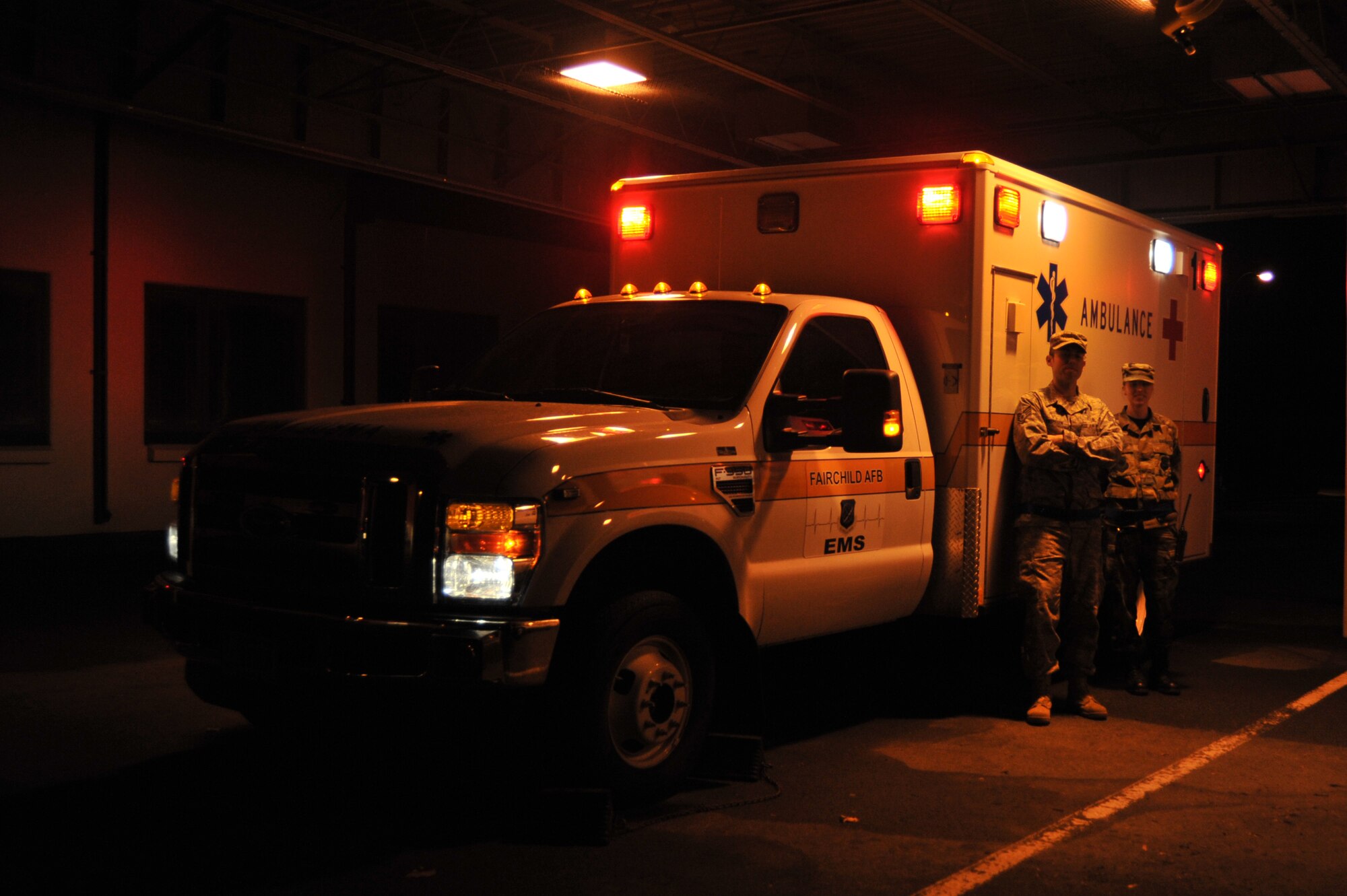 Staff Sgt. Thomas Andresen and Senior Airman Amanda Colyer, 92nd Medical Group ambulance crew, pose in the night next to Med1, the newest ambulance on Fairchild. In addition to responding to emergency calls, the night crew also conducts after hour telephone consultations.
