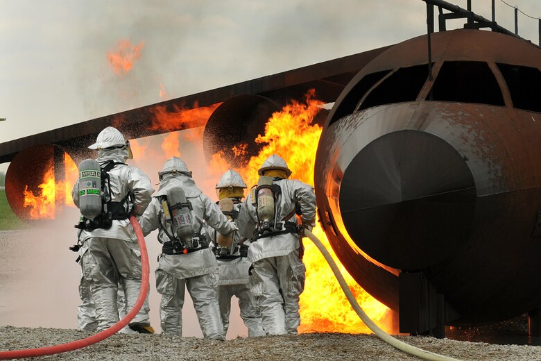 OFFUTT AIR FORCE BASE Neb.-- Offutt firefighters extinguish the flames in a simulated aircraft fire trainer during a joint training exercise here May 4. Firefighters from Offutt, Omaha's Eppley Airfield and guard and reserve units participated in the training exercise.

U.S. Air Force Photo by Charles Haymond
