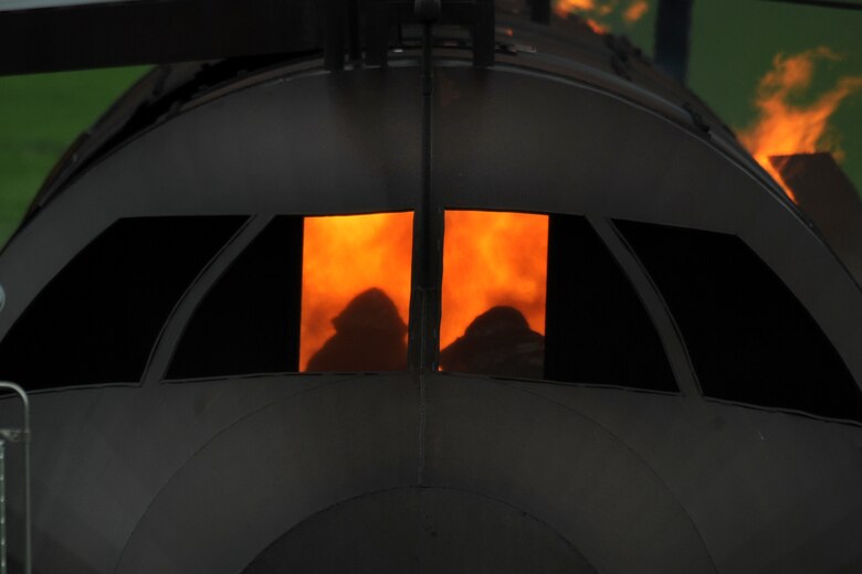 OFFUTT AIR FORCE BASE Neb. - Offutt firefighters extinguish the flames in a simulated aircraft fire trainer during a joint training exercise here May 6. Firefighters from Offutt, Omaha's Eppley airfield and guard and reserve units participated in the training.

U.S. Air Force Photo by Josh Plueger