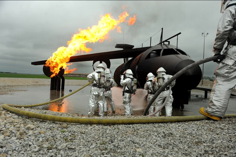 OFFUTT AIR FORCE BASE Neb. - Offutt firefighters extinguish the flames in a simulated aircraft fire trainer during a joint training exercise here May 6. Firefighters from Offutt, Omaha's Eppley airfield and guard and reserve units participated in the training.

U.S. Air Force photo by Josh Plueger