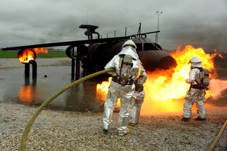OFFUTT AIR FORCE BASE Neb. -- Offutt firefighters extinguish the flames oin a simulated aircraft fire trainer during a joint training exercise here May 6. Firefighters from Offutt, Eppley airfield and guard and reserve units participated in the training.

U.S. Air Force photo by Josh Plueger
