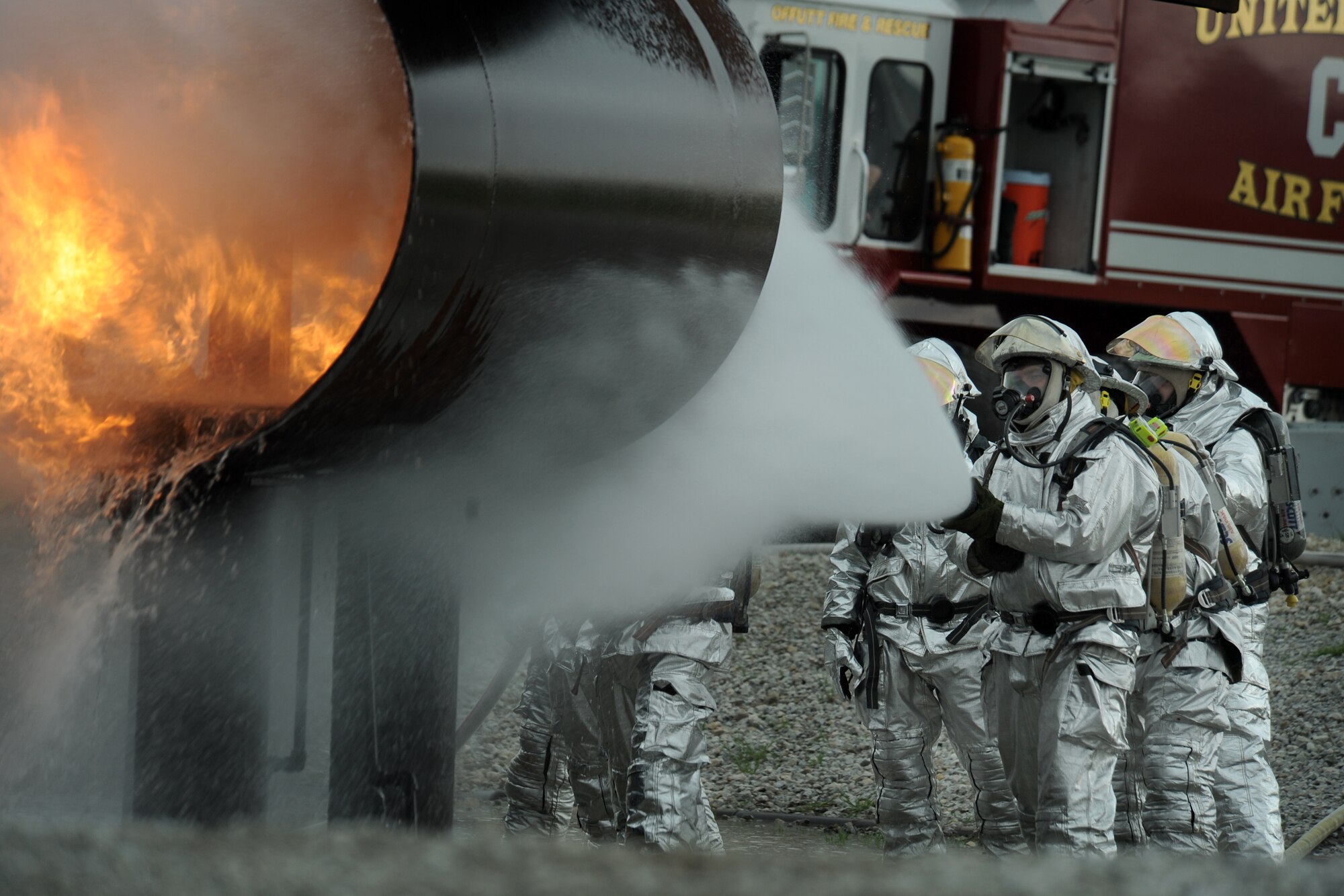OFFUTT AIR FORCE BASE Neb. -- Offutt firefighters extinguish the flames in a simulated aircraft fire trainer during a joint training exercise here May 6. Firefighters from Offutt, Eppley airfield and guard and reserve units participated in the training.

U.S. Air Force photo by Josh Plueger