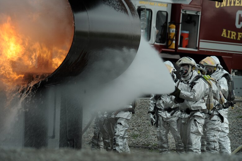 OFFUTT AIR FORCE BASE Neb. -- Offutt firefighters extinguish the flames in a simulated aircraft fire trainer during a joint training exercise here May 6. Firefighters from Offutt, Eppley airfield and guard and reserve units participated in the training.

U.S. Air Force photo by Josh Plueger