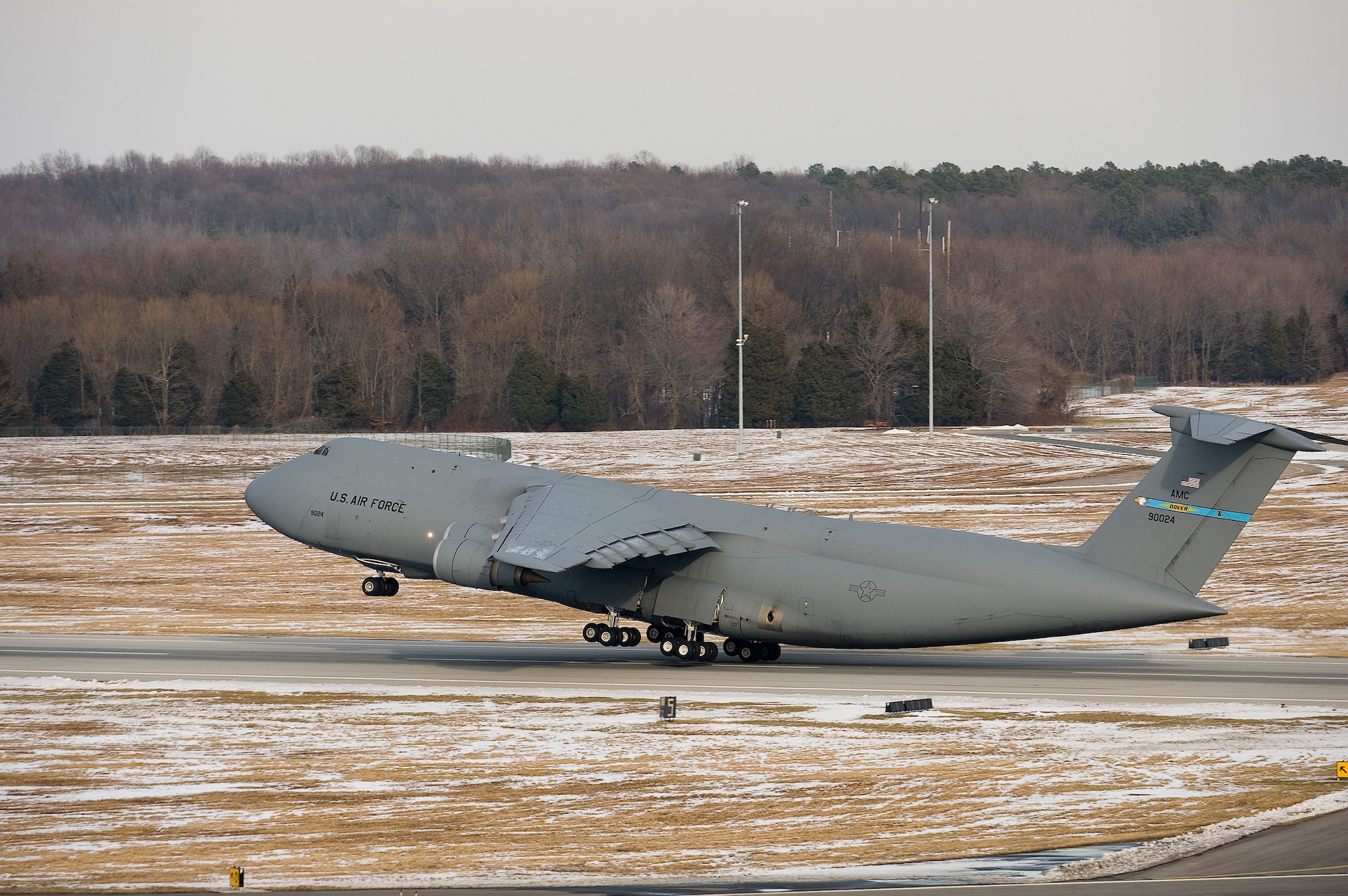 A C-5 Galaxy takes off from Dover Air Force Base Feb. 4, as Team Dover attempted to launch most of the aircraft at the installation.  Team Dover worked to launch the aircraft and empty the flightline to simplify snow removal efforts after a snow storm dumped 18 measurable inches of snow on the installation. (U.S. Air Force photo/Jason Minto)