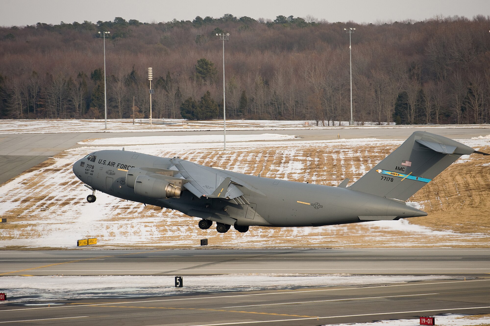A C-17 Globemaster III departs Dover Air Force Base Feb. 4 on a mission to deliver cargo.  Team Dover worked with the 618th Tanker/Airlift Control Center to get missions for the aircraft at Dover to clear the flightline before a snow storm dumped 18 measurable inches of snow on the installation. Missions for the aircraft ranged from supporting humanitarian relief efforts in Haiti to delivering cargo to American forces in Southwest Asia. (U.S. Air Force photo/Jason Minto)