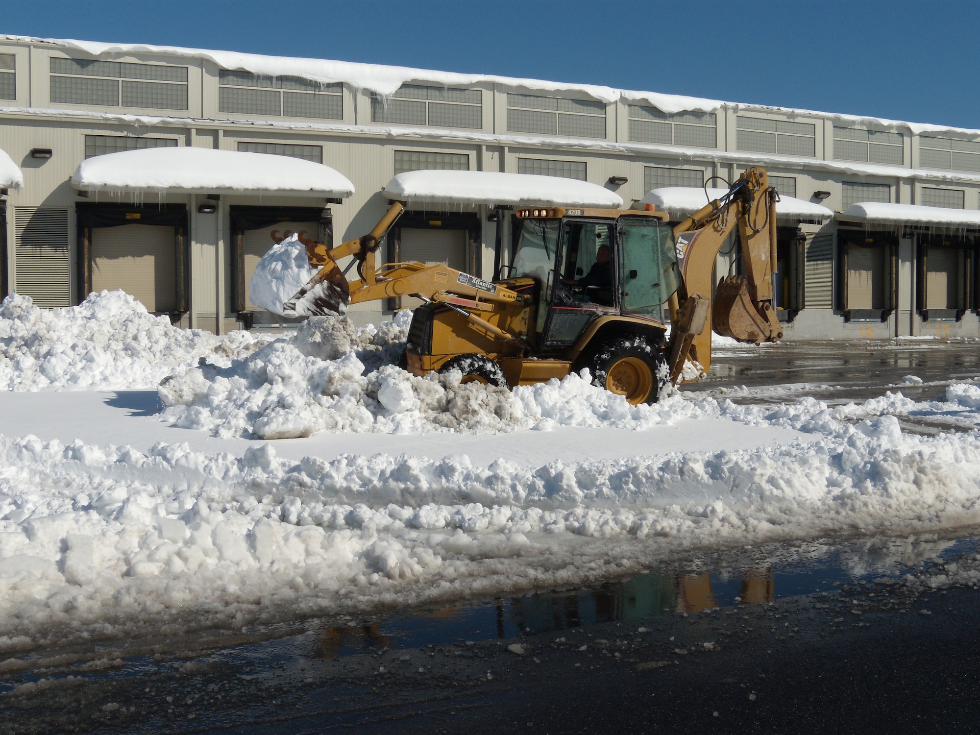 A Team Dover member removes snow from the loading docks at the Dover Air Force Base Aerial Port.  Team Dover worked to clear the snow that blanketed the installation Feb. 6, and to keep operations going. (U.S. Air Force photo/1st Lt. Brian Maguire)