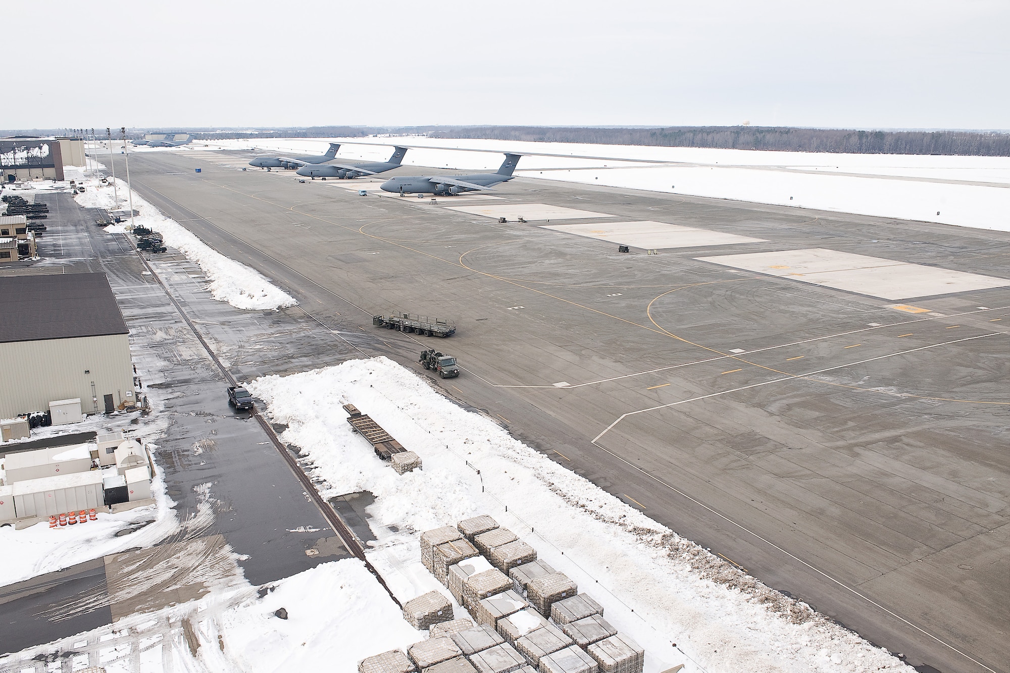 A handful of aircraft are parked on the Dover Air Force Base flightline Feb. 9.  Team Dover launched all available aircraft Feb. 4 and 5 on 618th Tanker/Airlift Control Center missions prior to a major snow storm blanketed the region.  By clearing most of the aircraft from the flightline, Team Dover was able to improve snow removal efforts and clear the flightline faster. (U.S. Air Force photo/Roland Balik) 