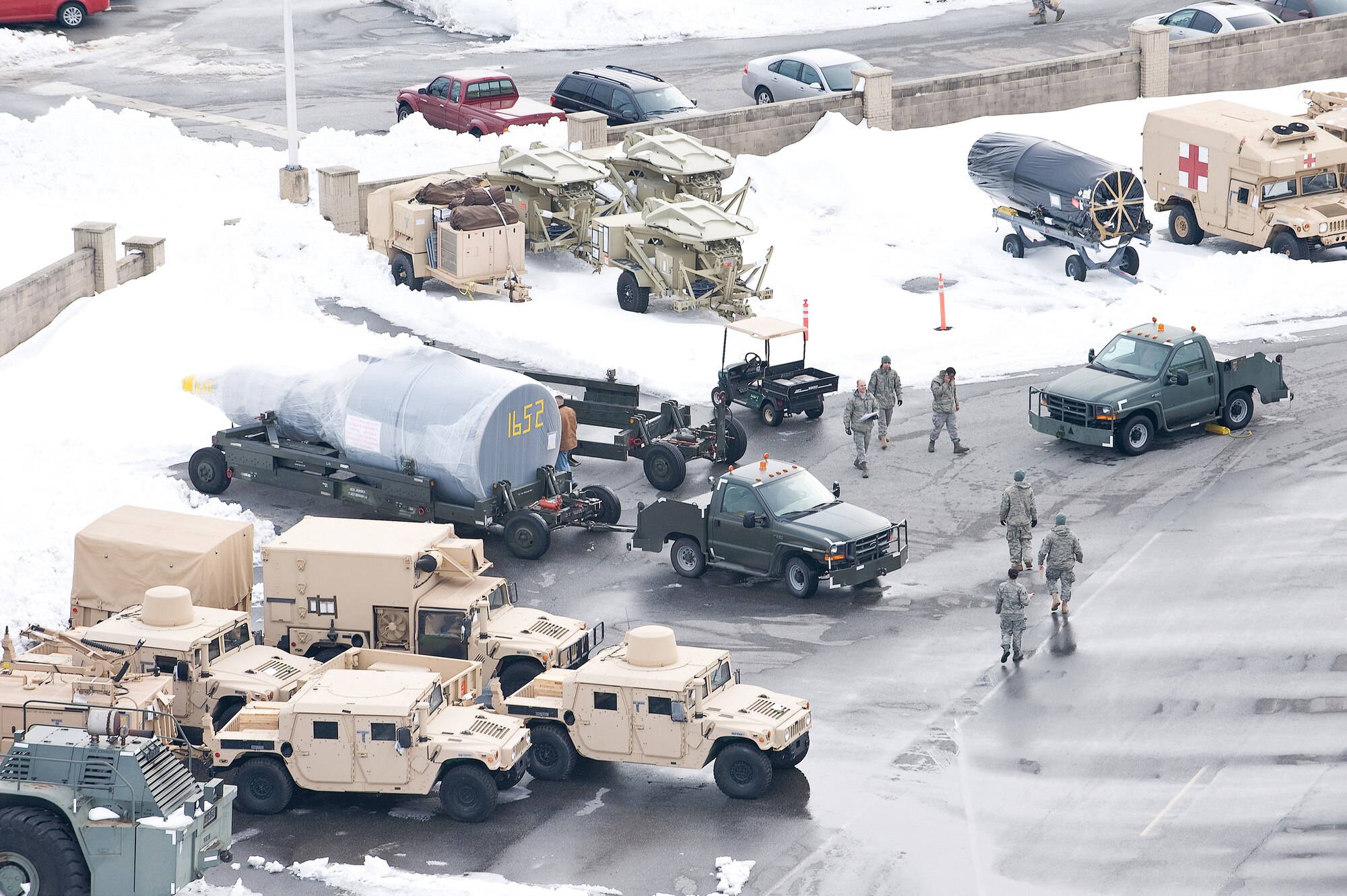 Airmen work in the outsize cargo yard at Dover Air Force Base Feb. 9.  After clearing snow from the Feb. 6 snow storm, Team Dover prepared for another round of snow Feb. 10. (U.S. Air Force photo/Roland Balik)