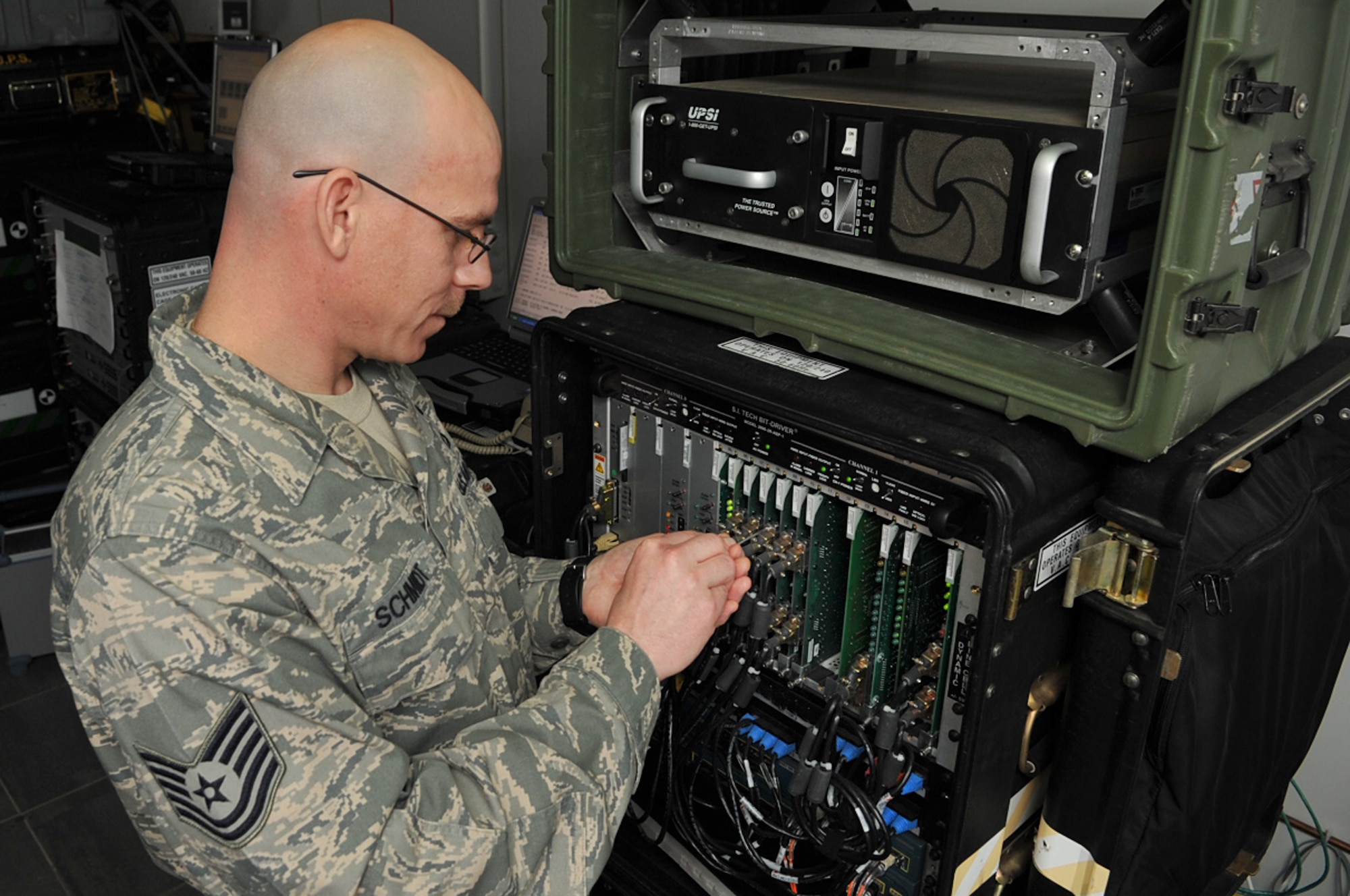 U.S. Air Force Tech. Sgt. Dennis Schmidt , transmission system technician, 1st Combat Communications Squadron, makes adjustments to a basic access module used to manage defense system network (DSN) lines, Krtsanisi National Training Center, Georgia, Feb. 9, 2010. Sergeant Schmidt is deployed to the Republic of Georgia to provide tactical communication support to the Marine Corps Training and Advisory Group as they teach combat skills to Georgian soldiers preparing to deploy to Afghanistan. (U.S. Air Force photo by Senior Airman Tony R. Ritter)
