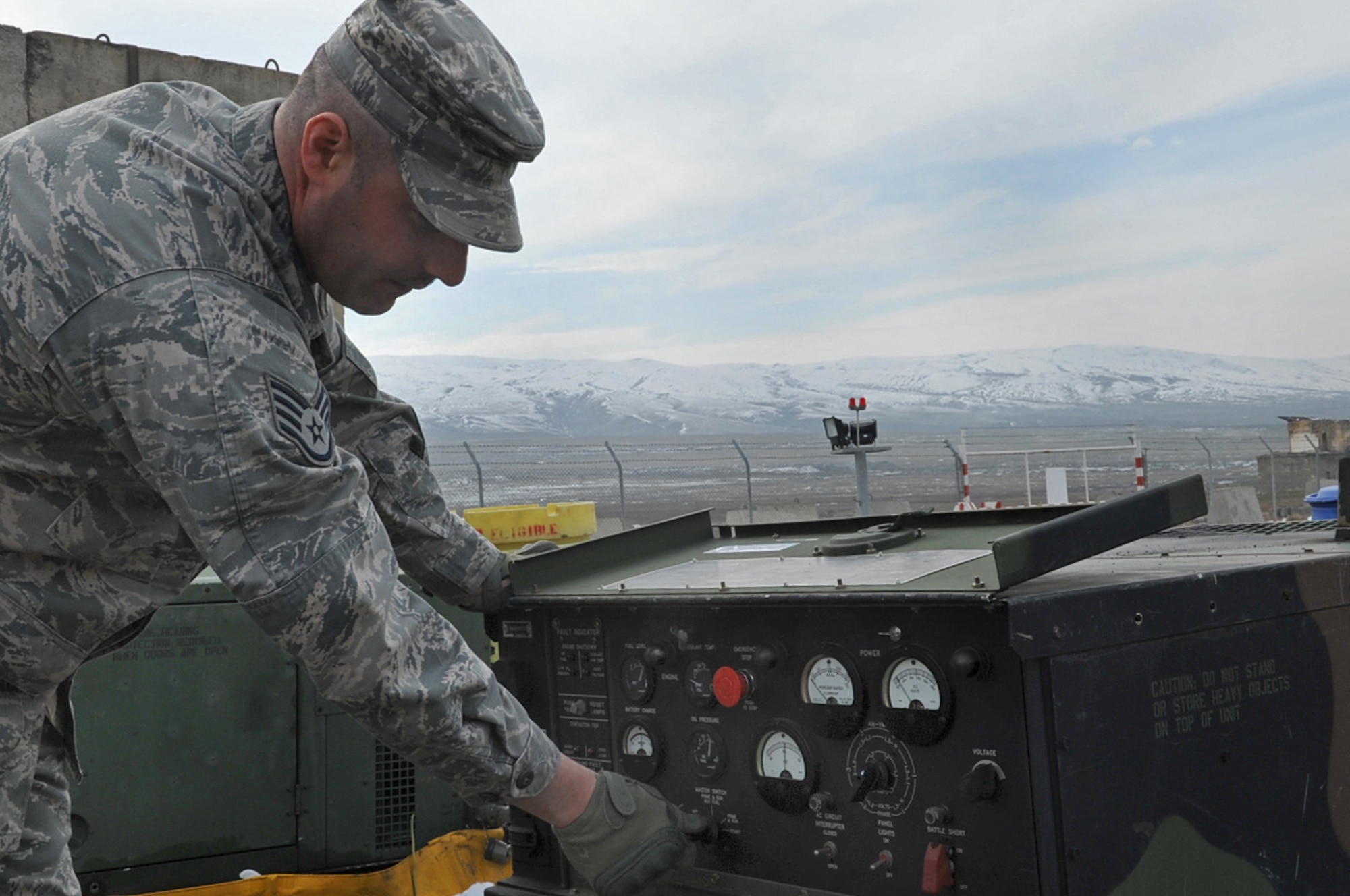 U.S. Air Force Staff Sgt. James Morgan, electrical power production technician, 1st Combat Communications Squadron, starts up a MEP 803 generator used to power equipment , Krtsanisi National Training Center, Georgia, Feb. 9, 2010. Sergeant Morgan is deployed to the Republic of Georgia to provide tactical communication support to the Marine Corps Training and Advisory Group as they teach combat skills to Georgian soldiers preparing to deploy to Afghanistan. (U.S. Air Force photo by Senior Airman Tony R. Ritter)