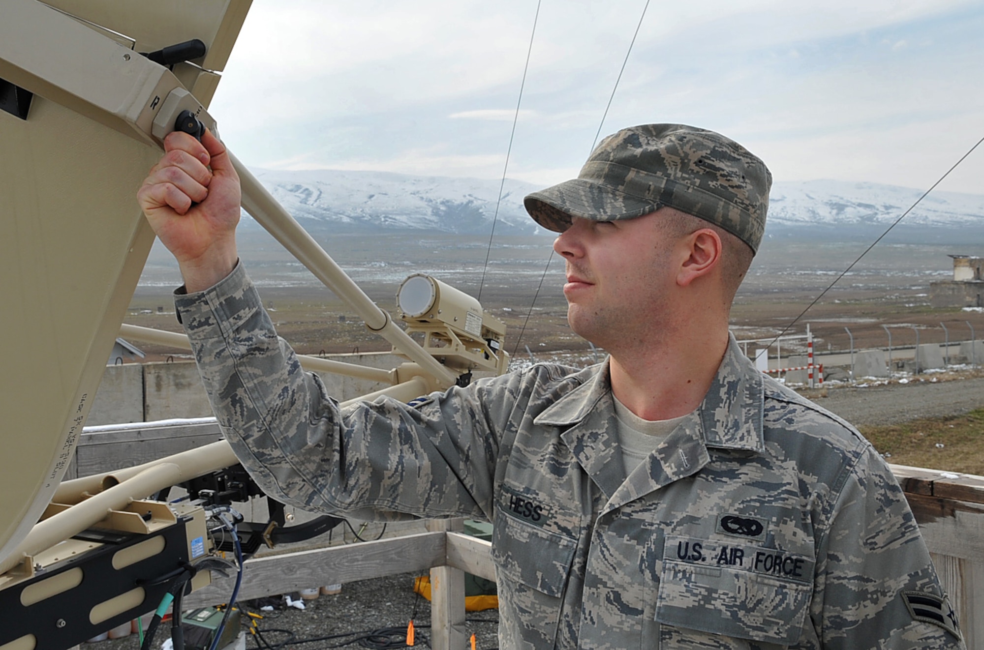 U.S. Air Force Airman 1st Class Evan Hess, transmission system technician, 1st Combat Communications Squadron, performs an operations check on a ground multi-band terminal used for long range communications, Krtsanisi National Training Center, Georgia, Feb.9, 2010. Airman Hess is deployed to the Republic of Georgia to provide tactical communication support to the Marine Corps Training and Advisory Group as they teach combat skills to Georgian soldiers preparing to deploy to Afghanistan. (U.S. Air Force photo by Senior Airman Tony R. Ritter)