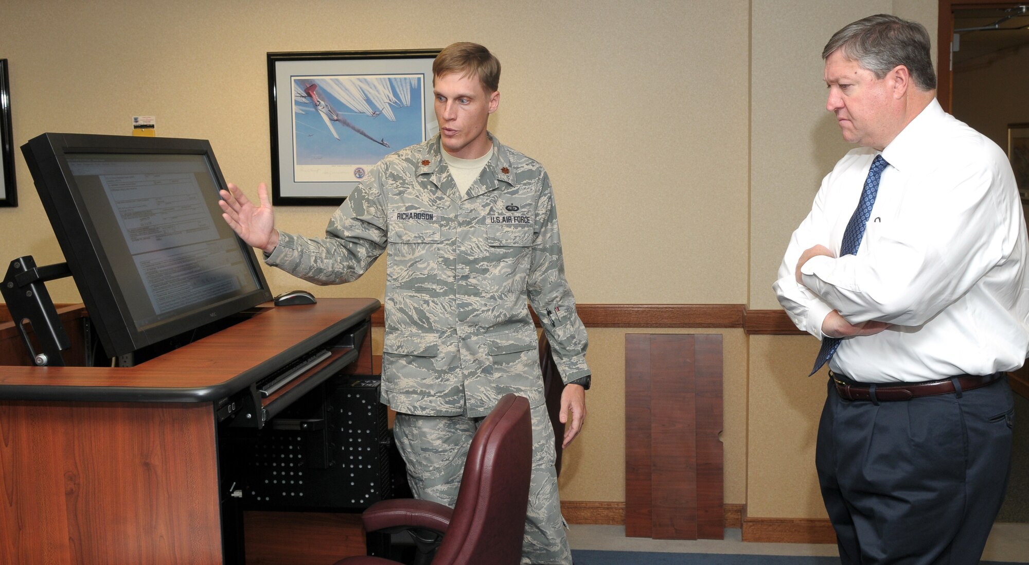 Maj. Ryan Richardson briefs Air Force Secretary Michael Donley on the new Electronic Board Opeation Support System at the Air Force Personnel Center during the secretary’s recent visit to Randolph Air Force Base, Texas. The mechanized workstations provide board members an ergonomic solution to viewing and scoring digital selection records using the eBOSS software suite that is projected to be fielded by the end of the year. The eBOSS will further assist in the elimination of hardcopy selection records across the total force. AFPC officials also had the opportunity to brief the Air Force secretary on a variety of personnel topics to include the Wounded Warrior program and air expeditionary force. Major Richardson is the senior recorder for the Air Force Selection Board Secretariat. (U.S. Air Force photo/Joel Martinez)