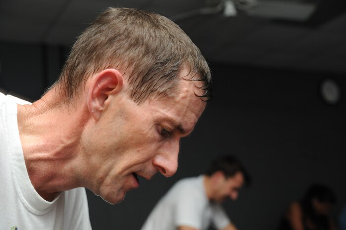 U.S. Air Force Lt. Col. John Robinson peddles intensely during a spinning class at the Fitness and Sports Center here Feb. 5, 2010. Spinning is primarily an aerobic exercise which  builds up muscular endurance over an extended period of time. Colonel Robinson is the chief of tactics with the 315th Operations Support Squadron. (U.S. Air Force photo/James M. Bowman)